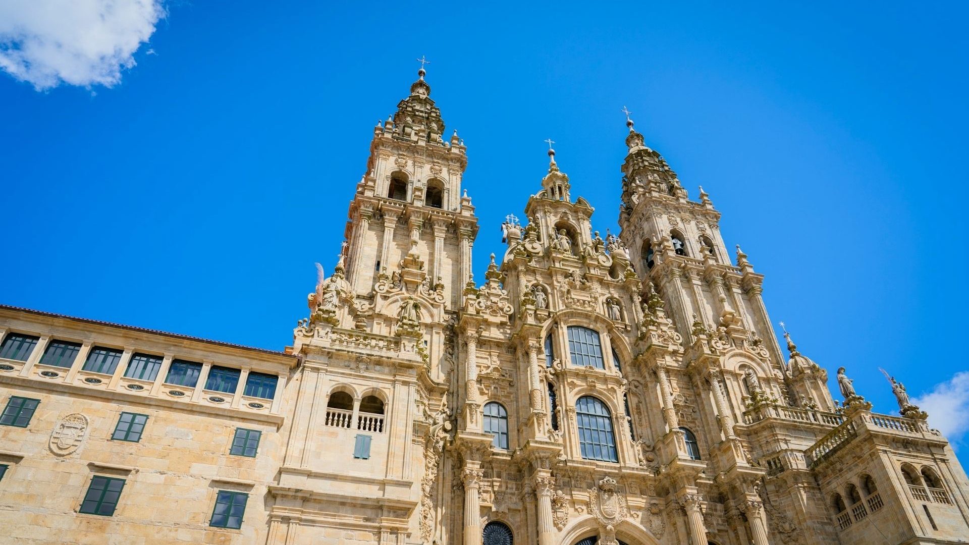 A majestic cathedral facade rises up into a blue sky