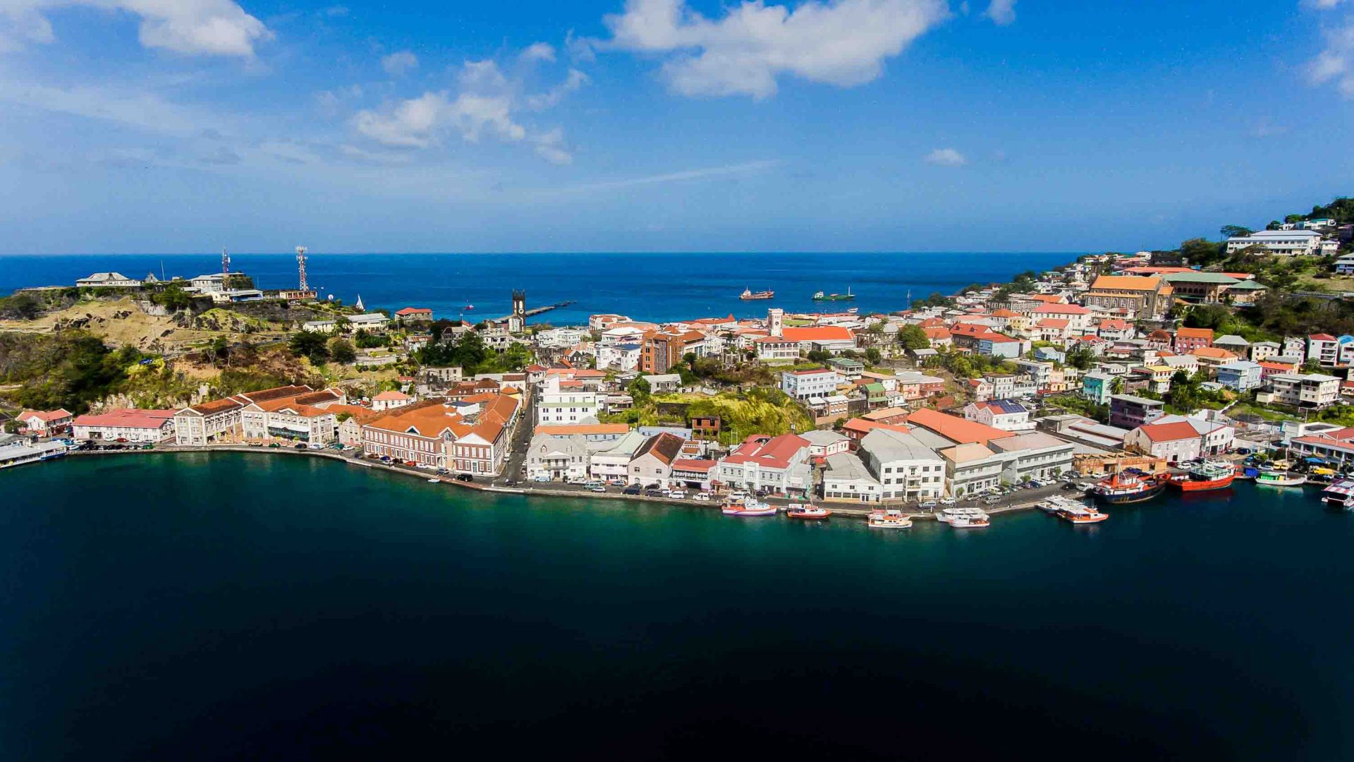 A wharf area with lots of houses, surrounded by sea.