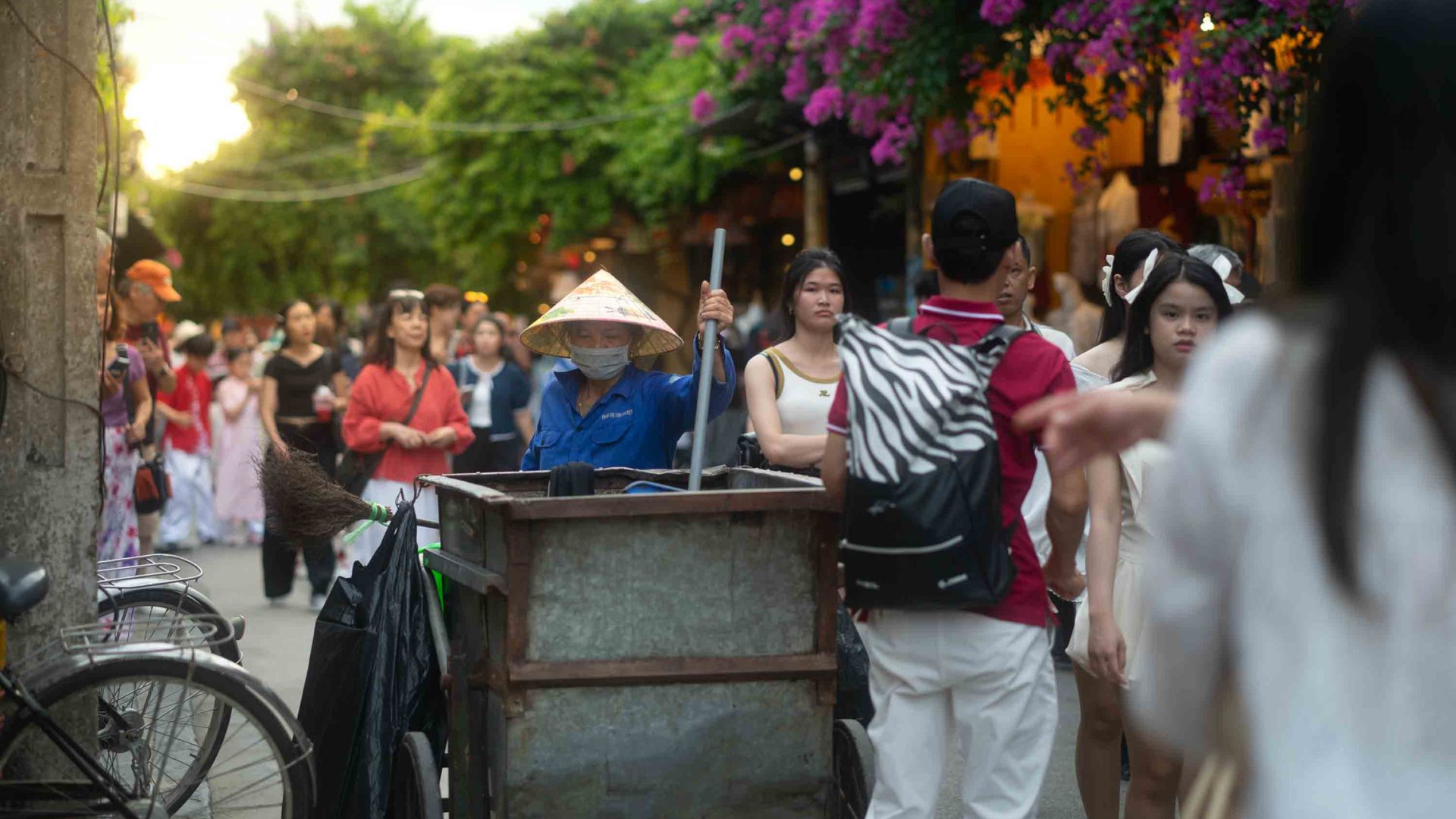 A street sweeper in bustling Hoi An.