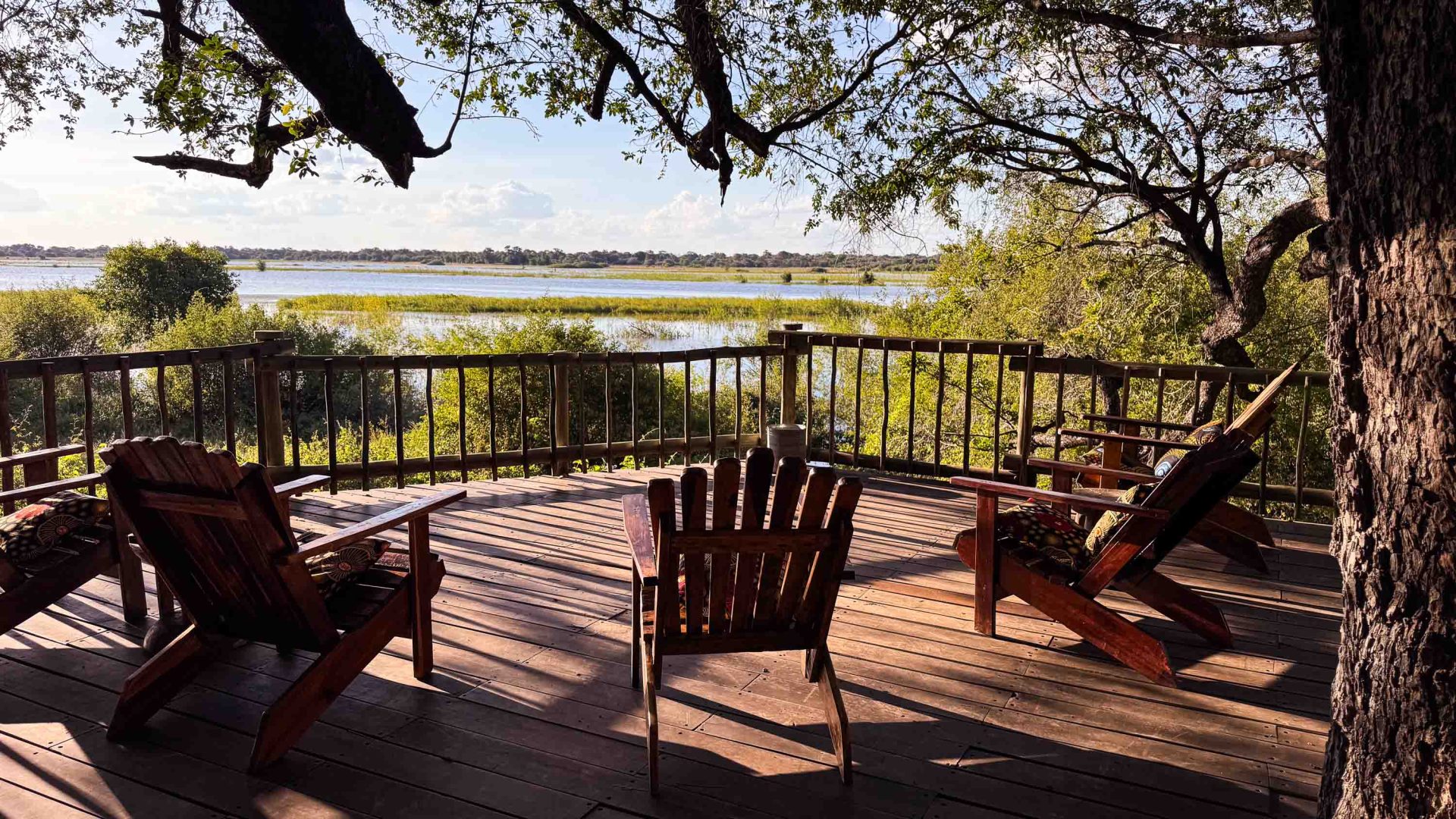 A deck with chairs overlooks a lagoon.