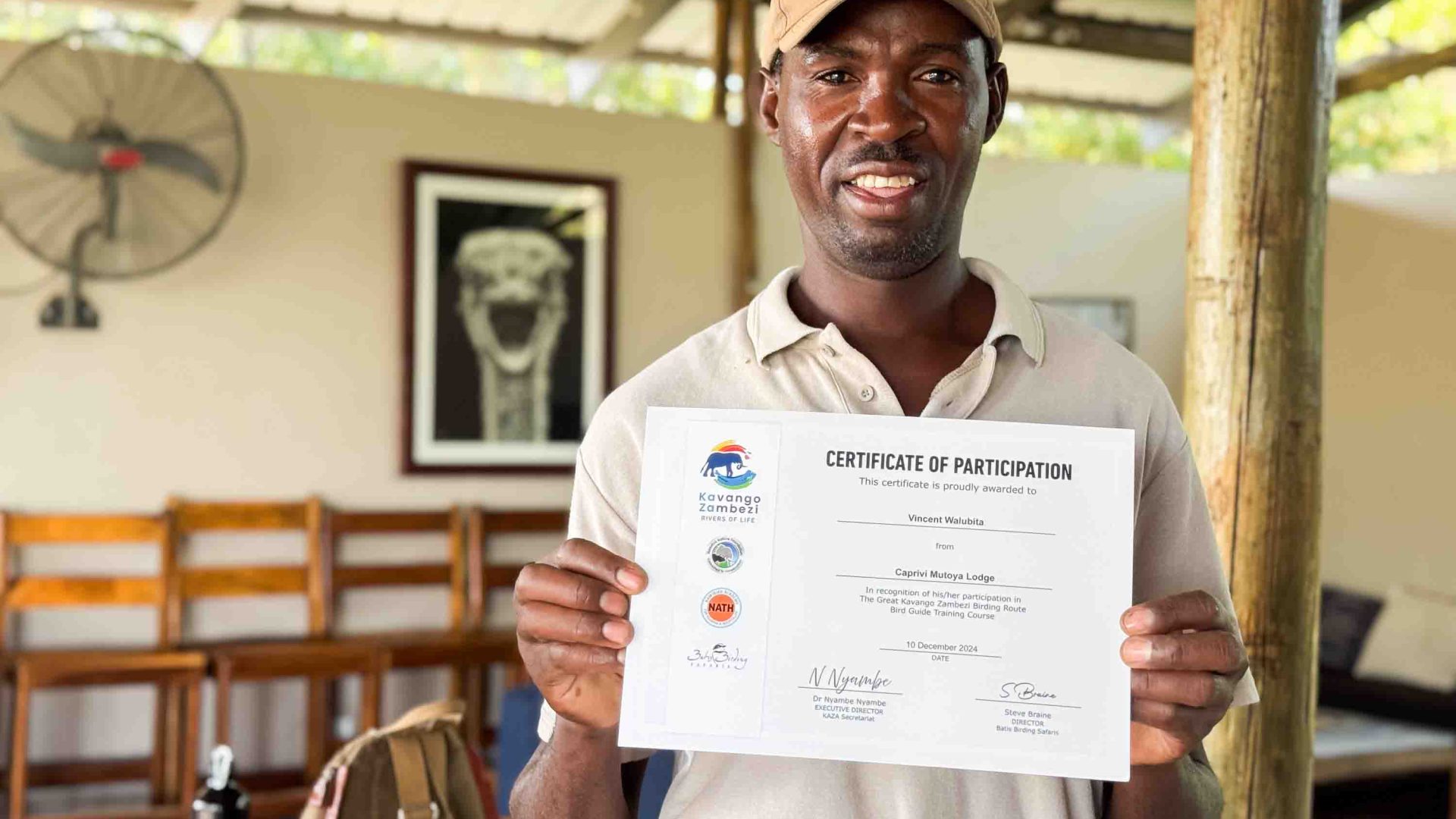 A man holds up a certificate.