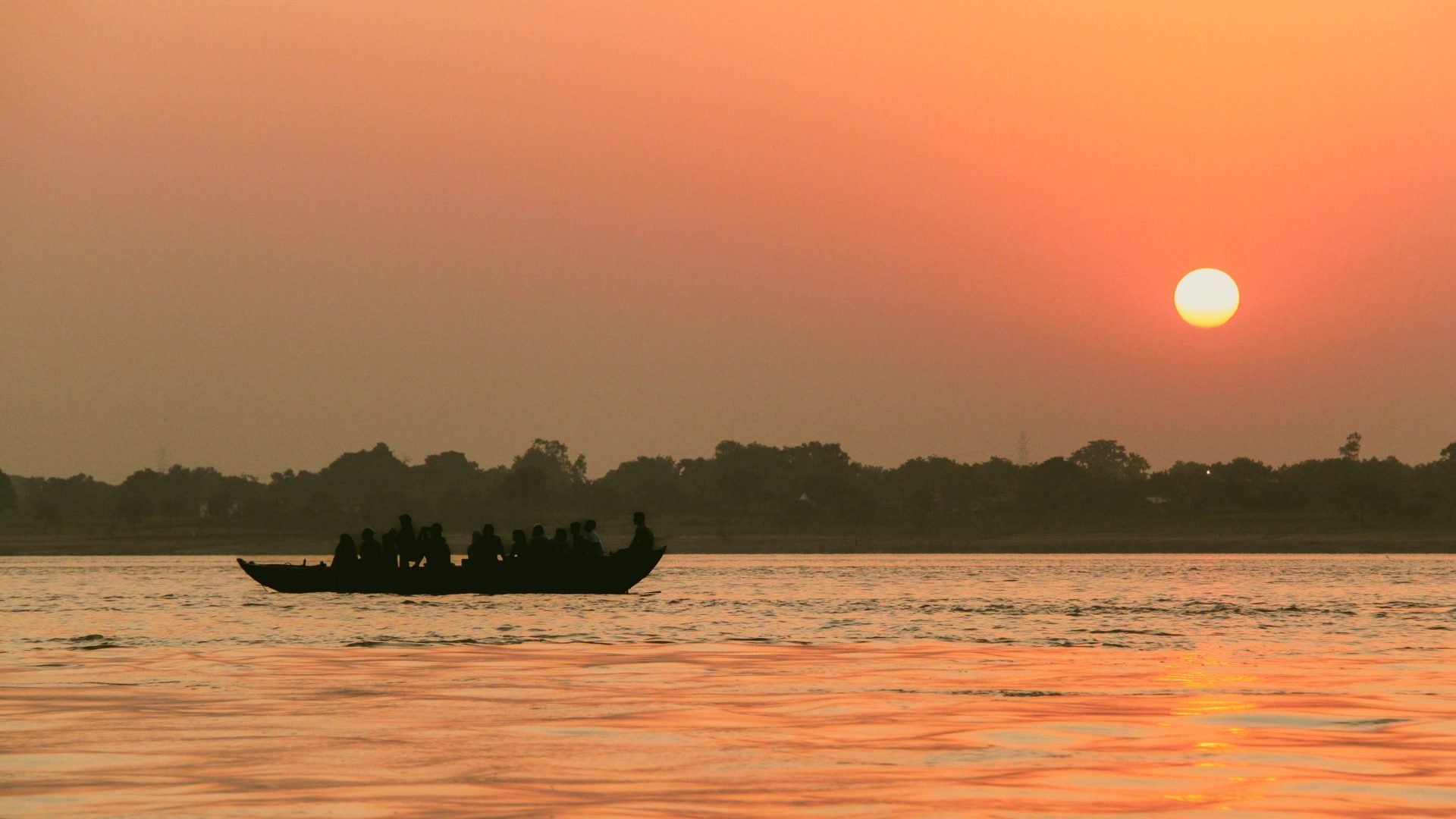 A boat on a river at sunset.