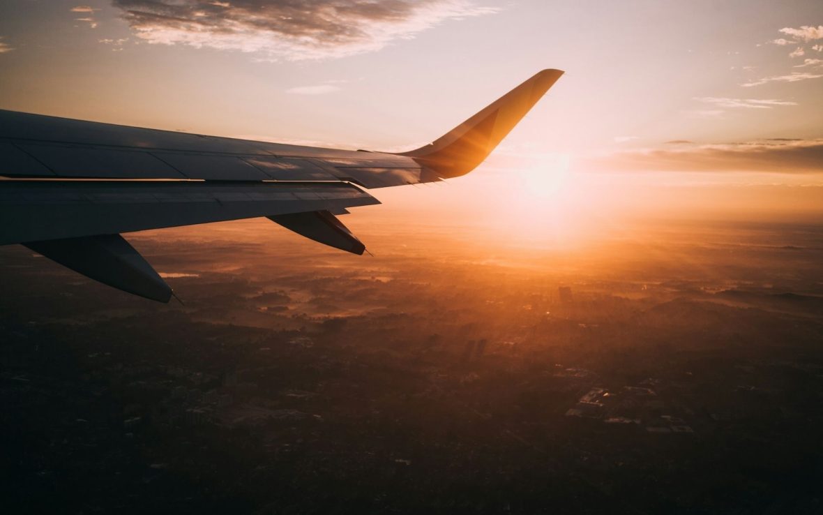 A plane above the clouds at sunset