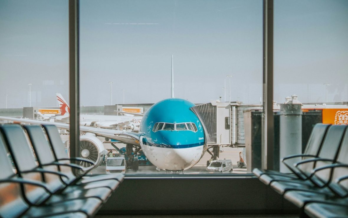 A shot of a plane through the windows at an airport terminal