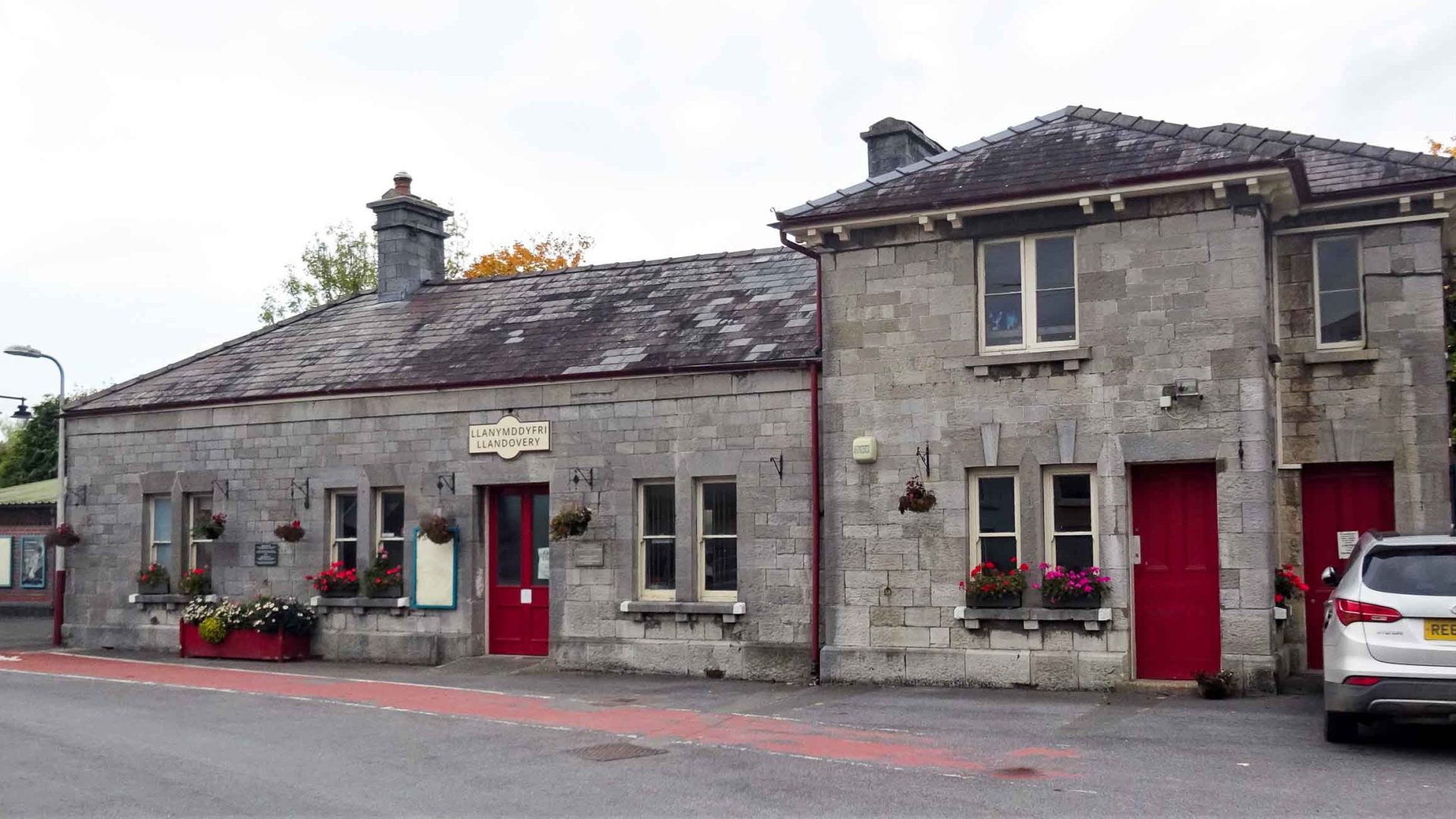 A grey stone railway station building.