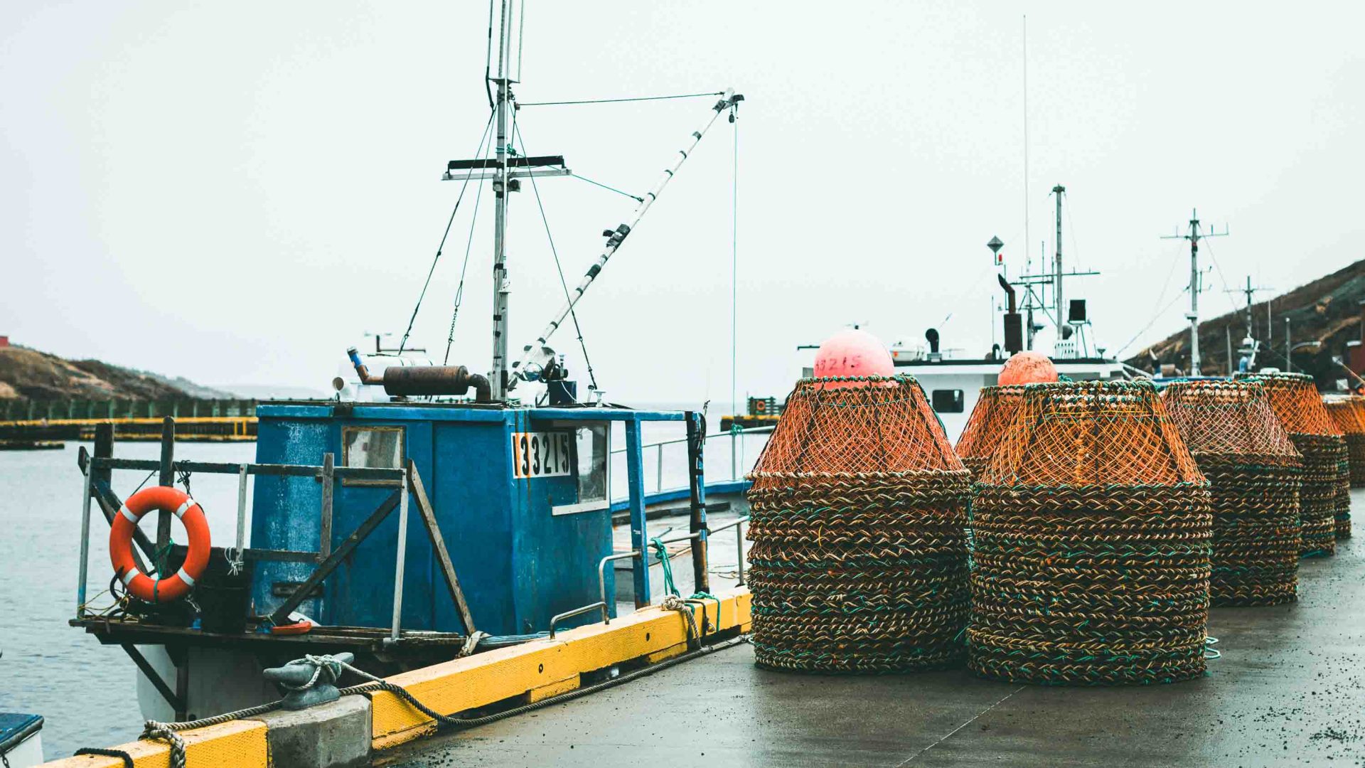A fishing boat and piles of nets.