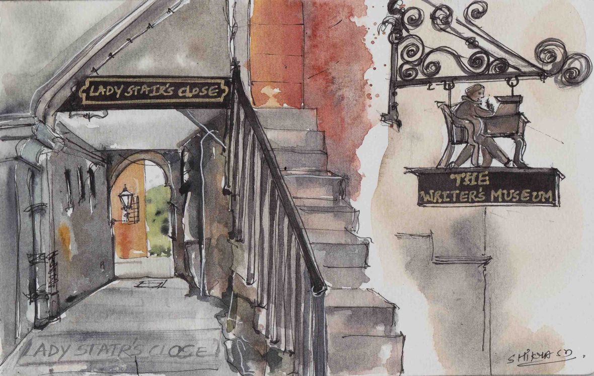 Stairs on the right and an archway on the left that leads to a small street.