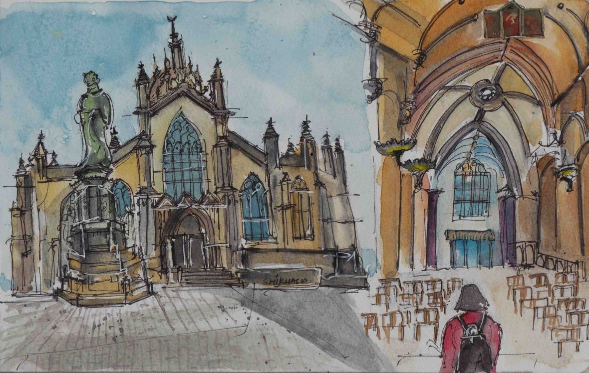 A woman in red walks towards a cathedral.