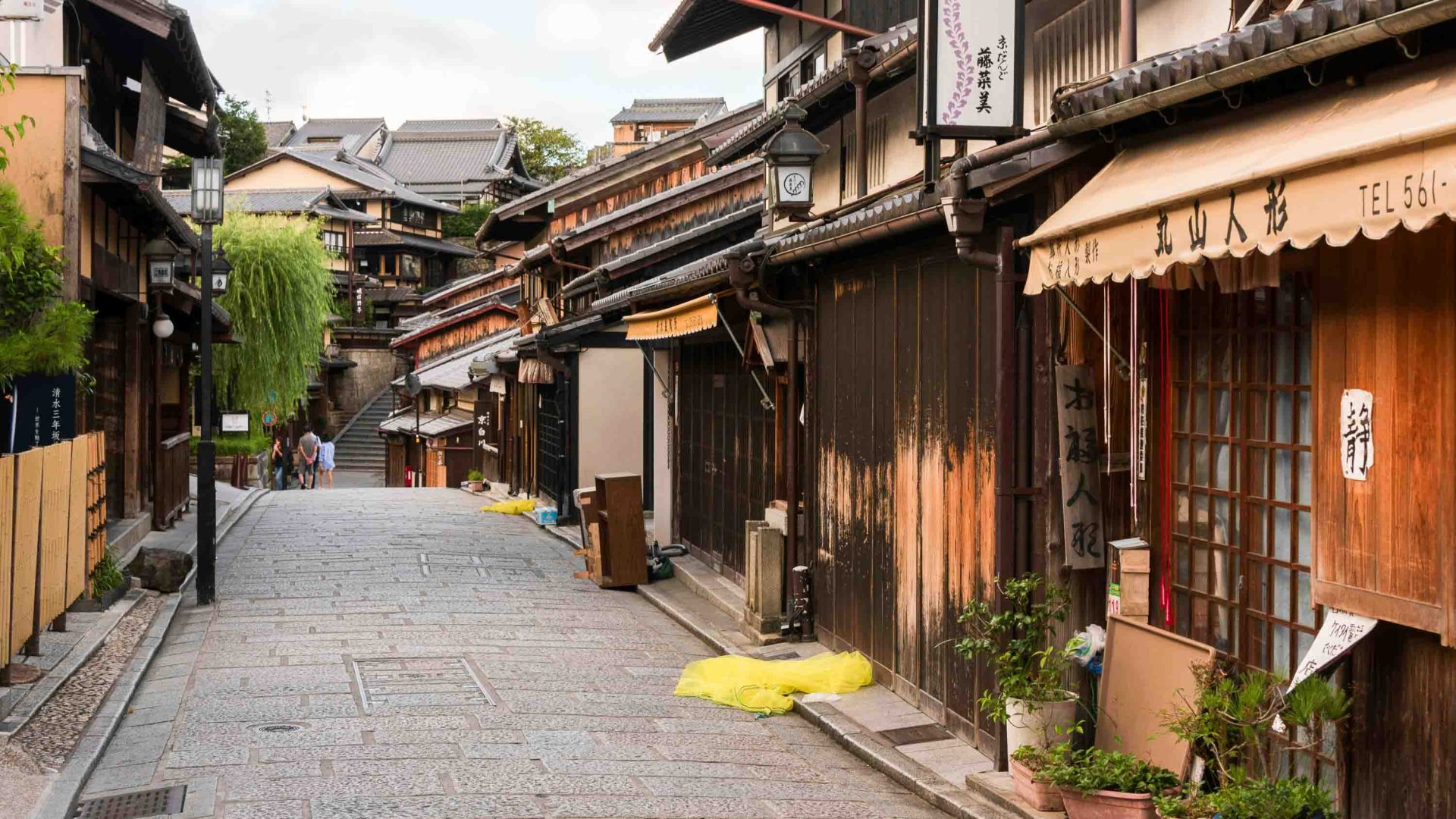 Japanese store fronts on a paved street.