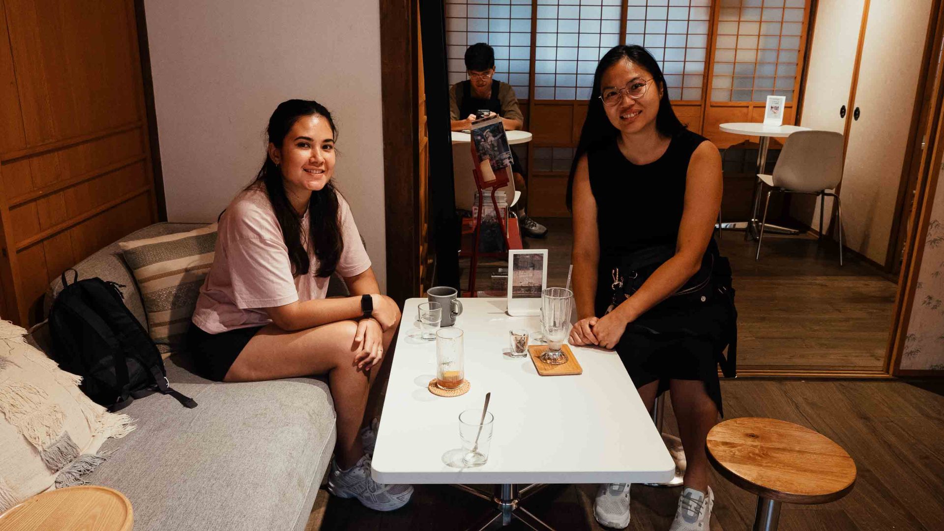 Two women sit at a table together in a restaurant.