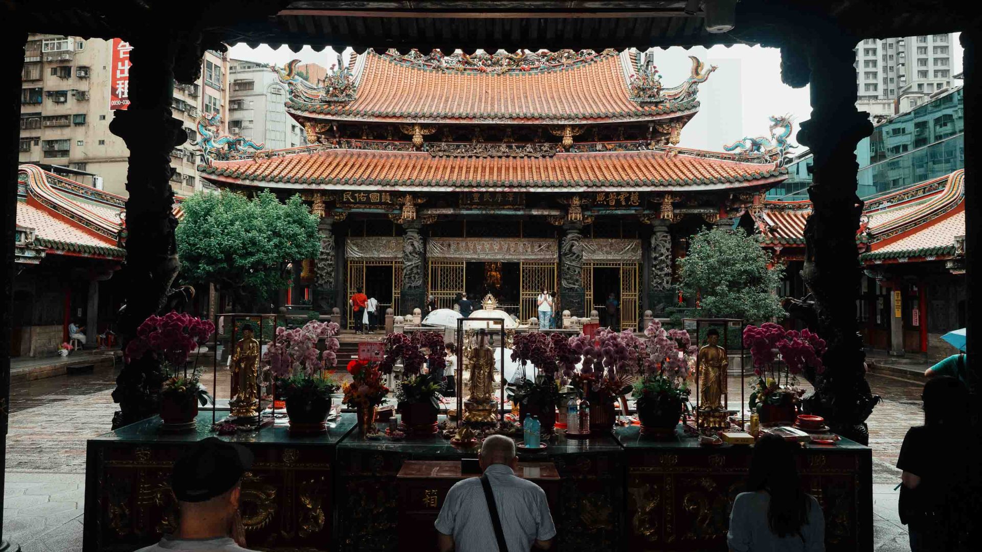 People stand outside a temple.
