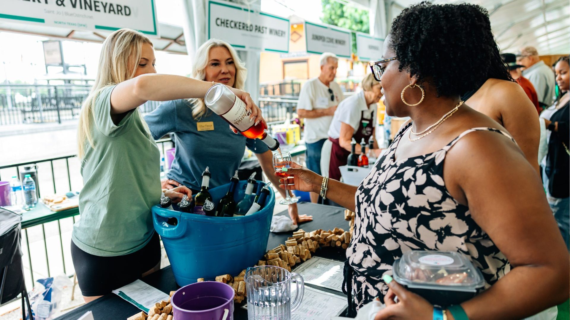 Three women pour wine