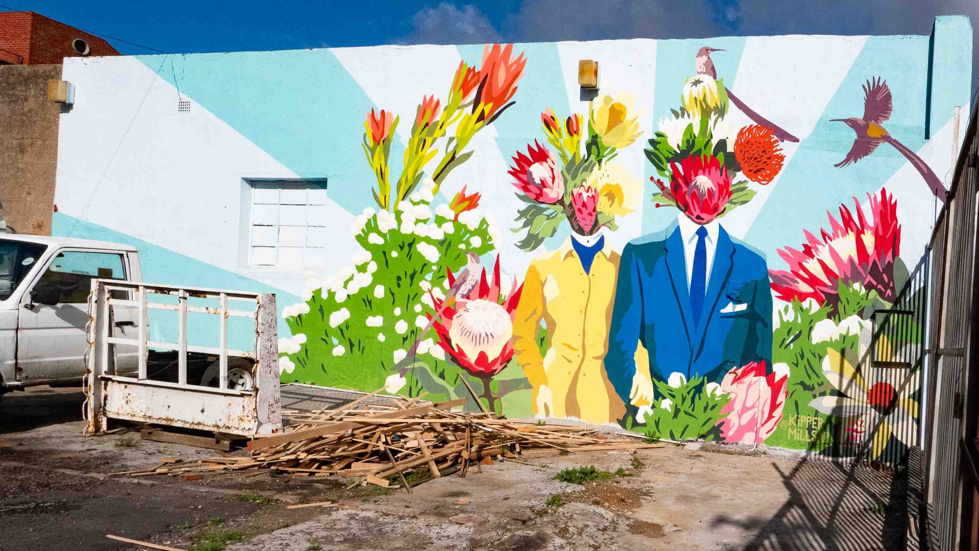 A mural showing flowers and a man with a flower for a face.