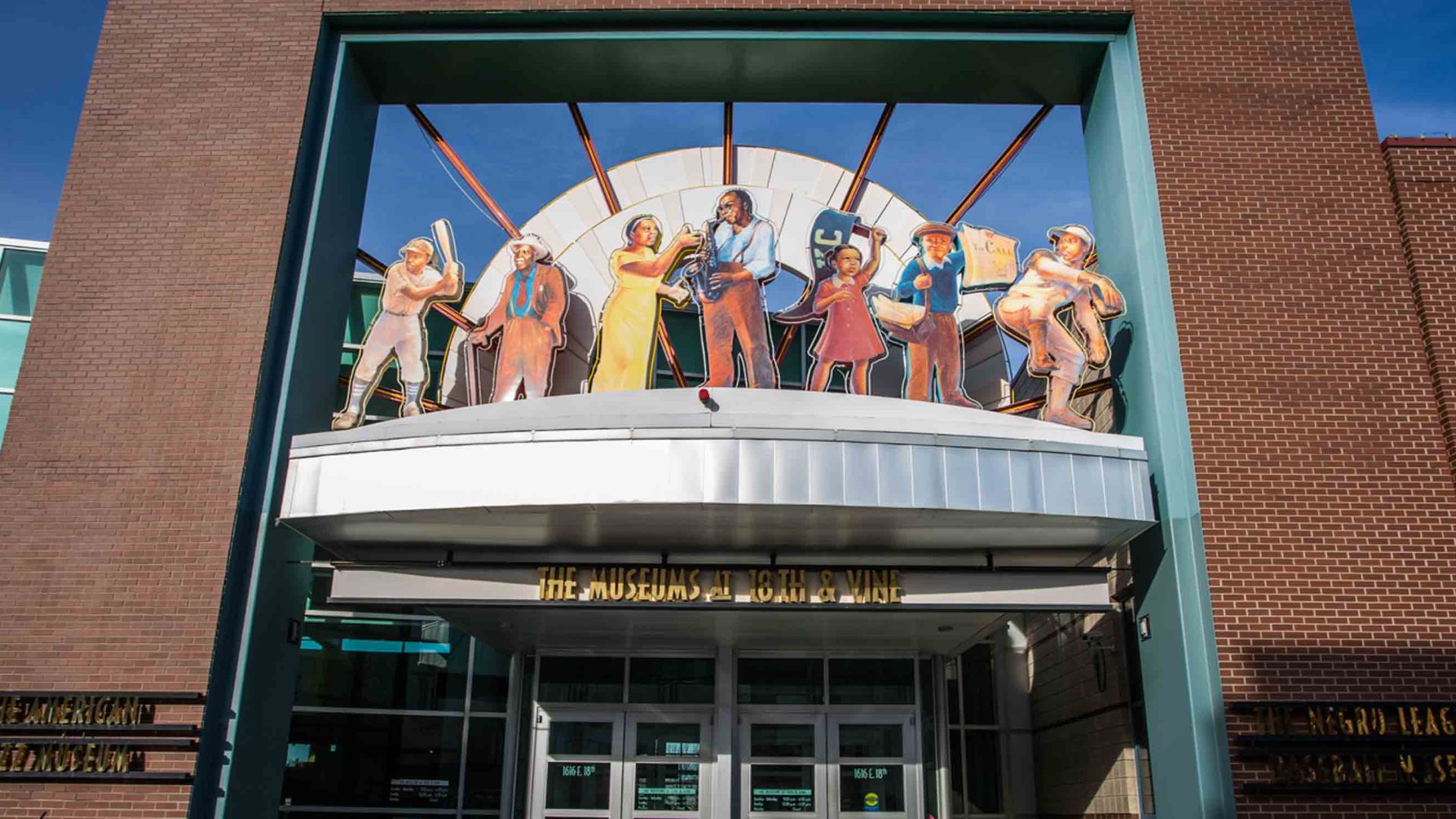 The entrance to a museum with colorful jazz statues above the door.