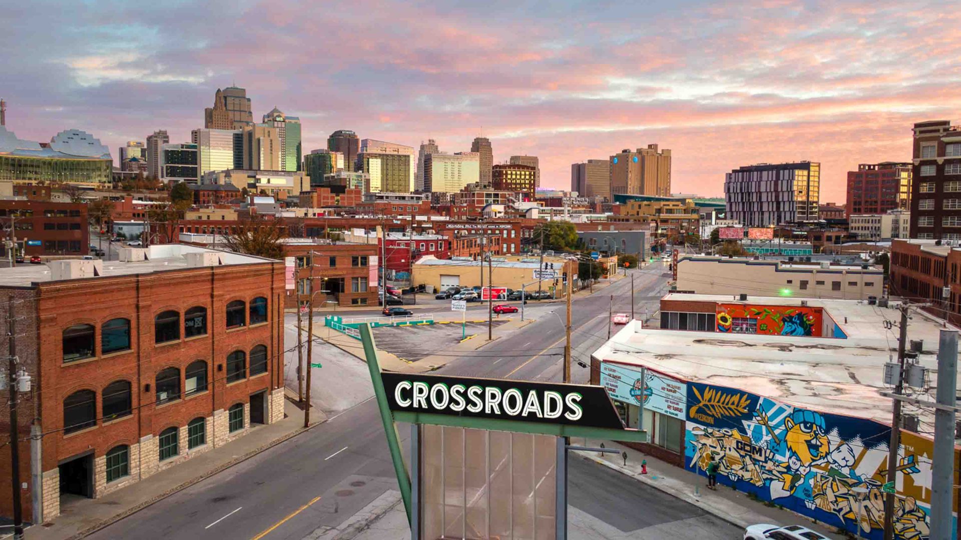 Buildings meet at an intersecting road where a sign says 'Crossroads'.