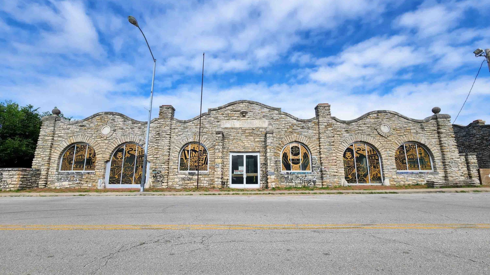 A long 19th-century limestone building with characterful windows.