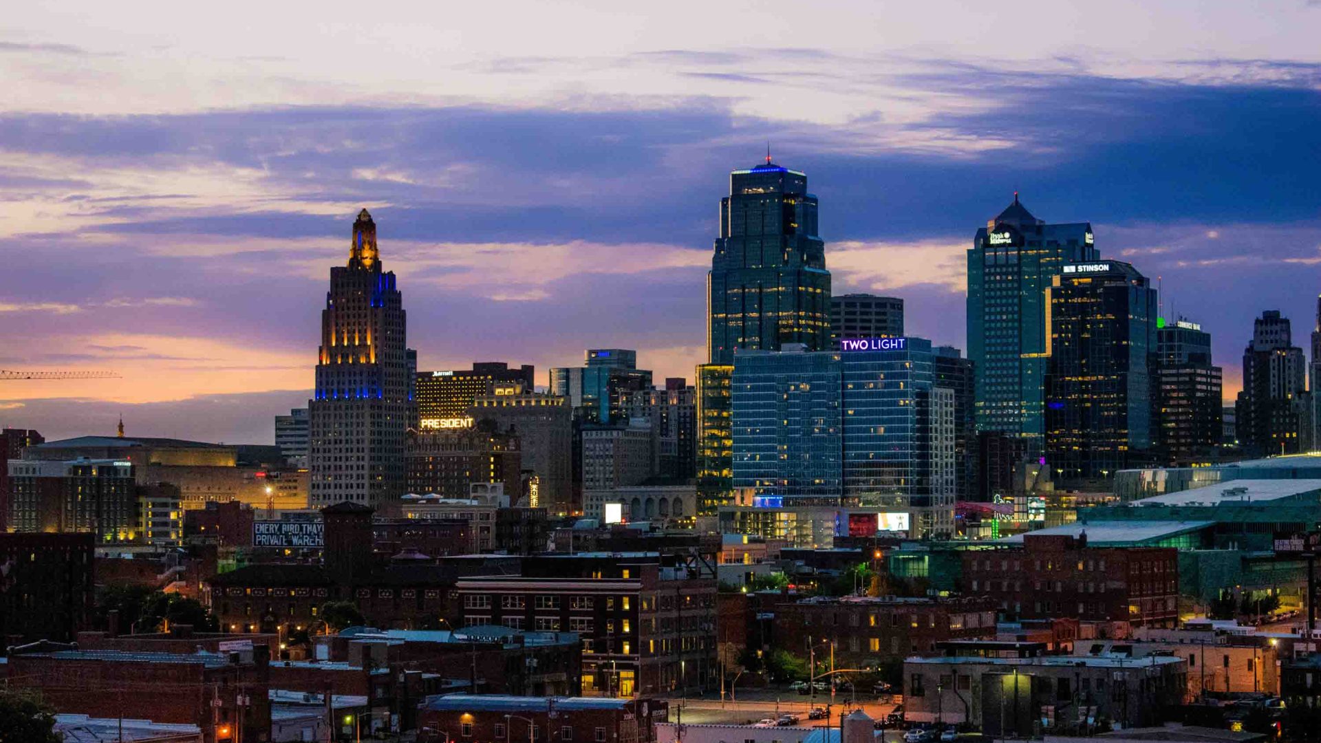 A city lit up at during the blue hour post-sunset.