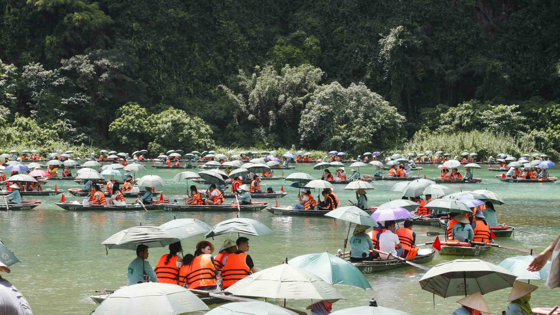 Waterways are crowded with tourists on boats.