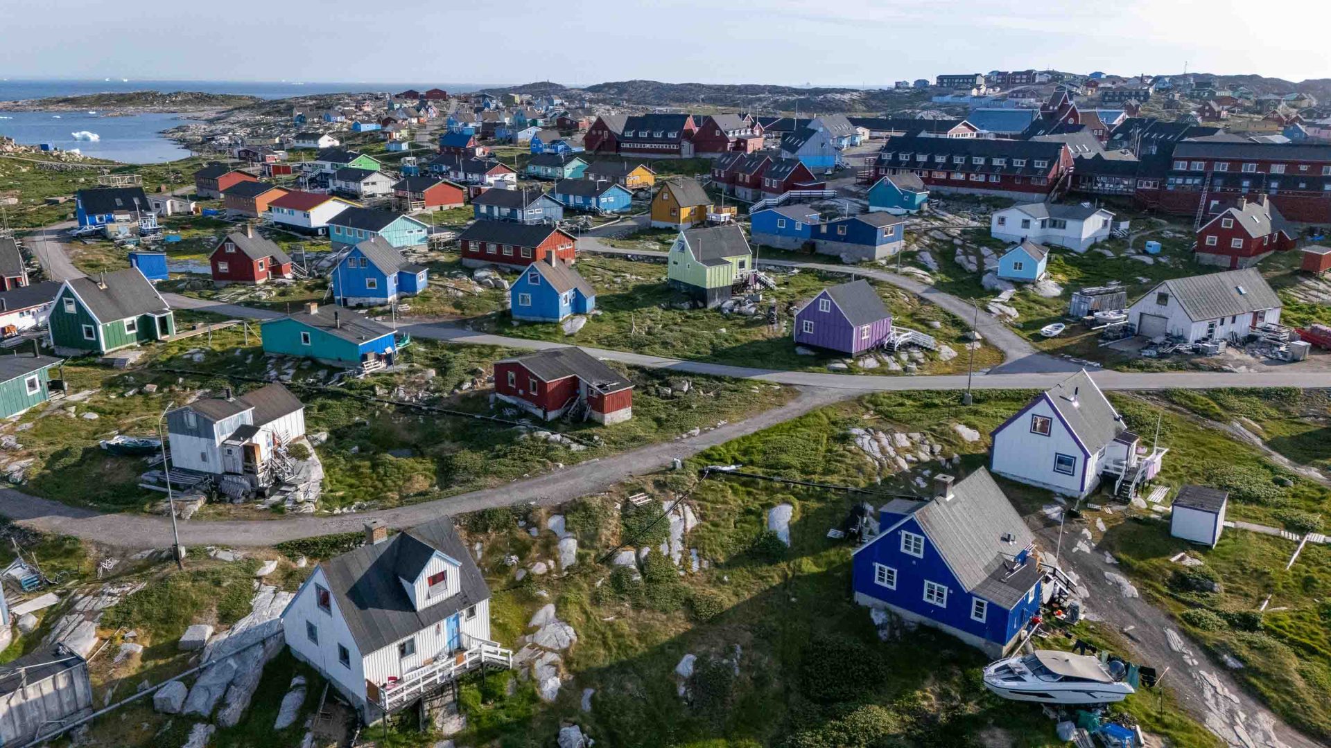 A town of colorful houses with roads winding through it.