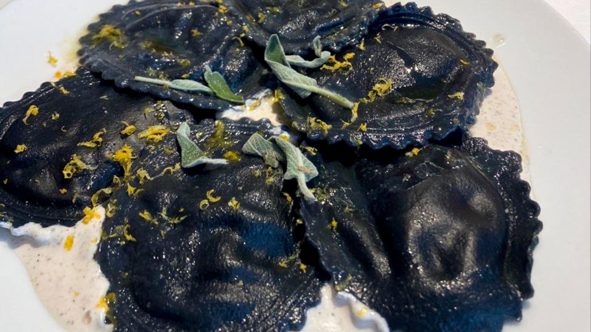 A plate of black raviolis.