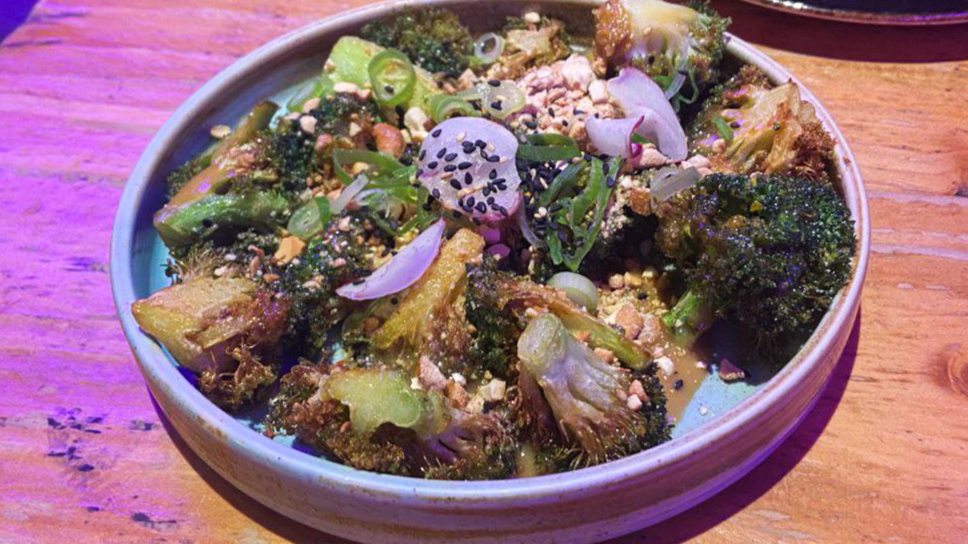A plate with broccoli and other vegetables.