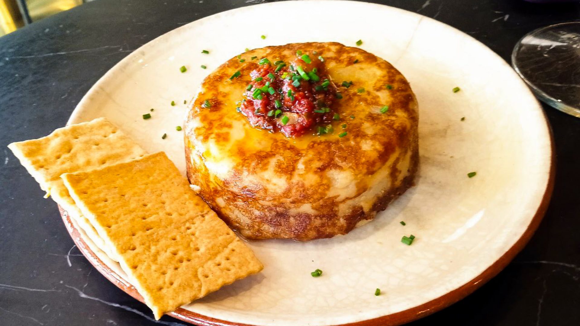 A plate with a potato omelette on it.