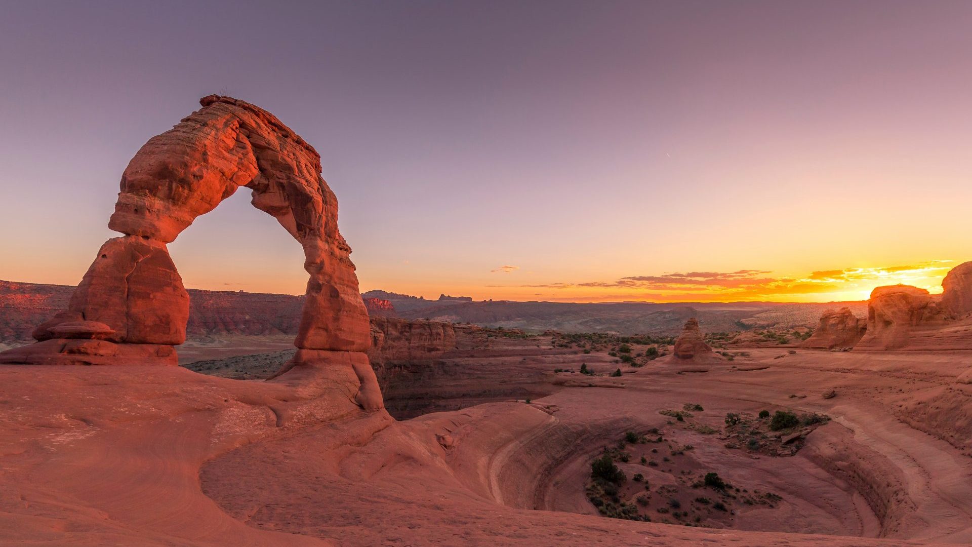 Rock arch framed against sunset.