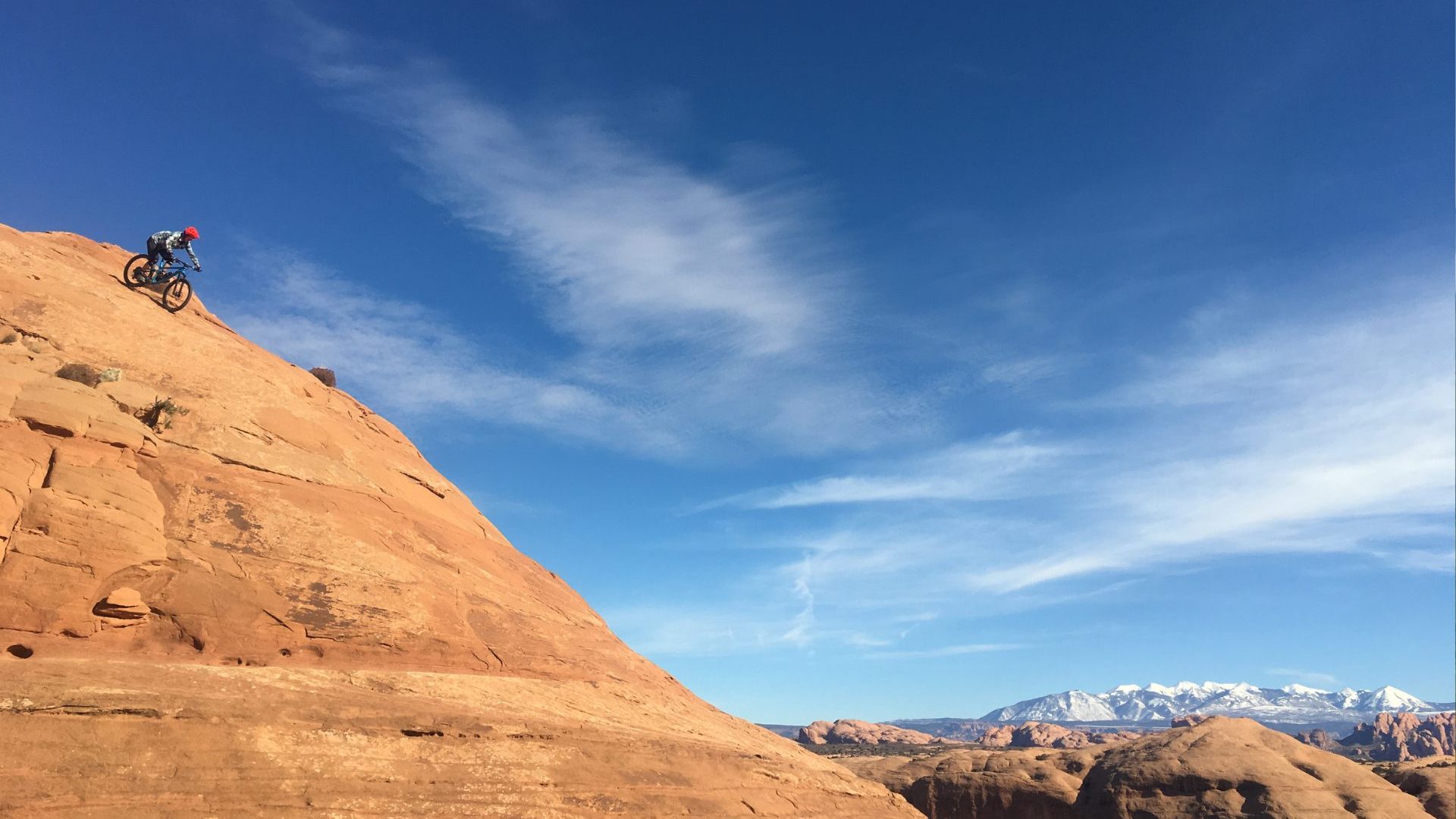 Mountain biker drops from top of rock
