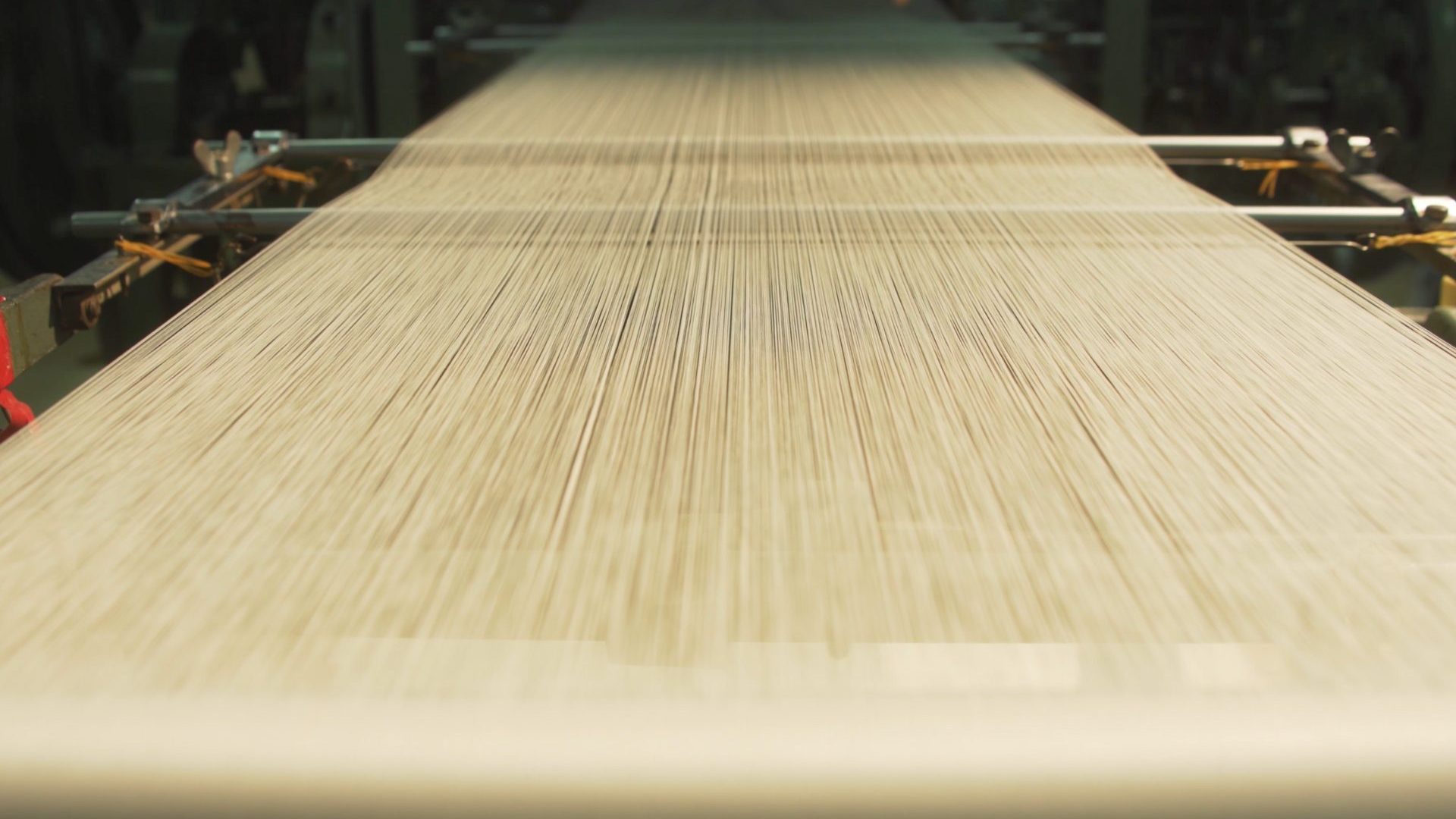 Blonde silk being weaved.