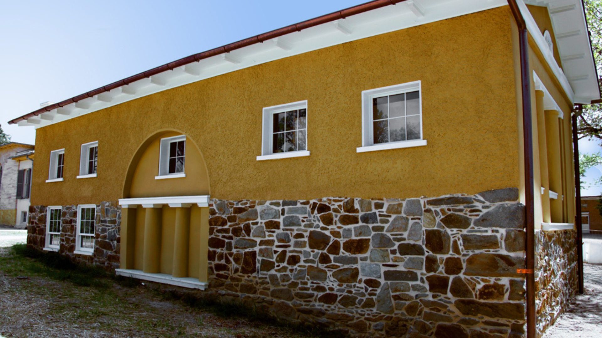 Brick and yellow building with small windows