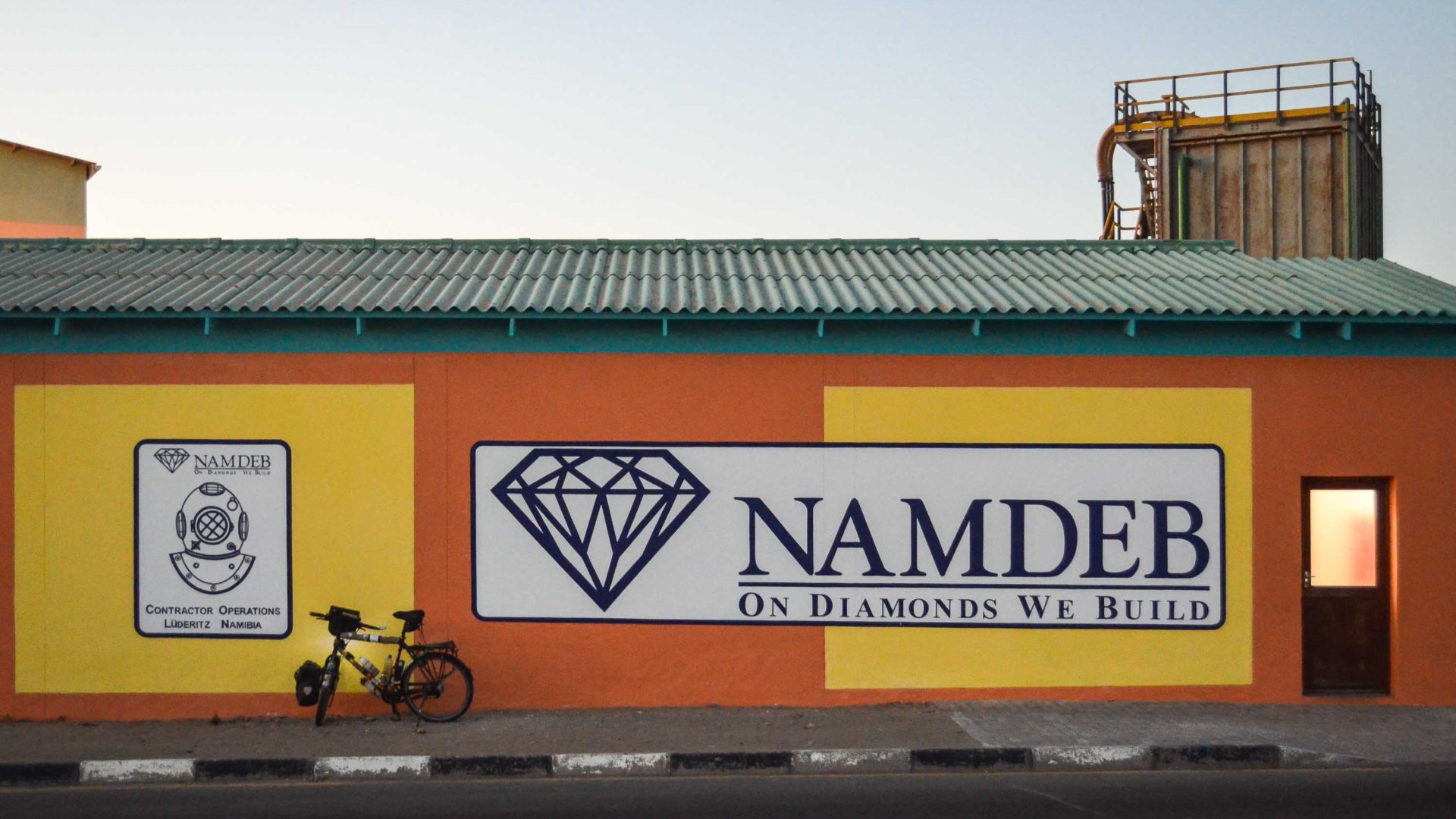 A yellow and orange building with the Nambed logo on it.