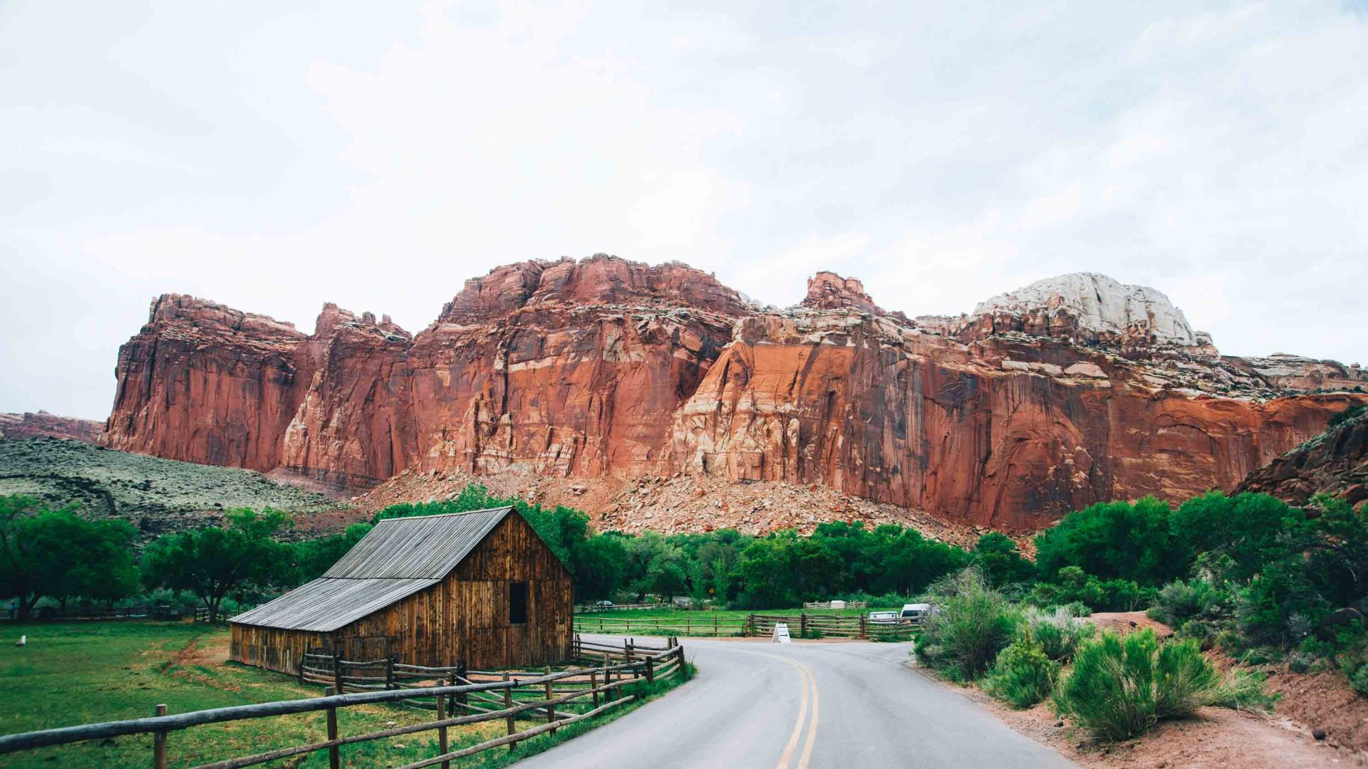 A small shack backed by red coloured mountains.