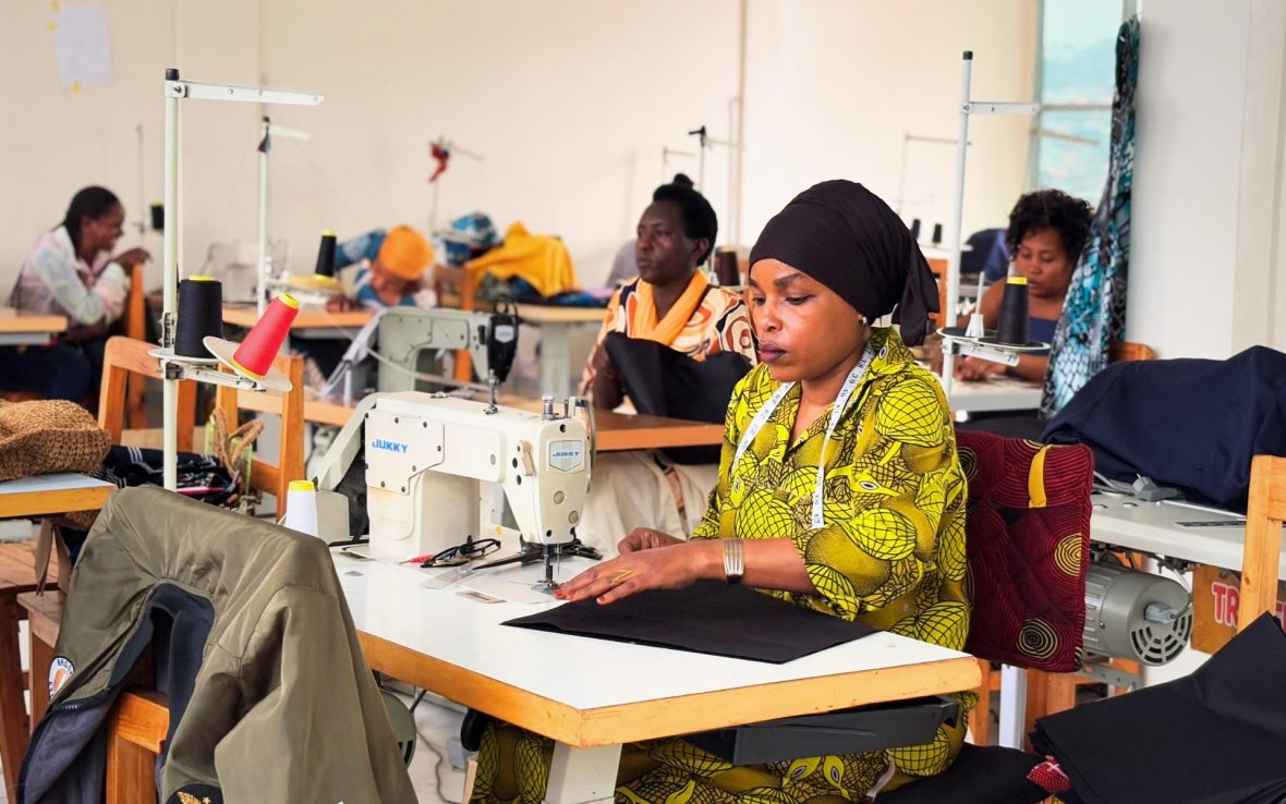 Women sit at sewing machines