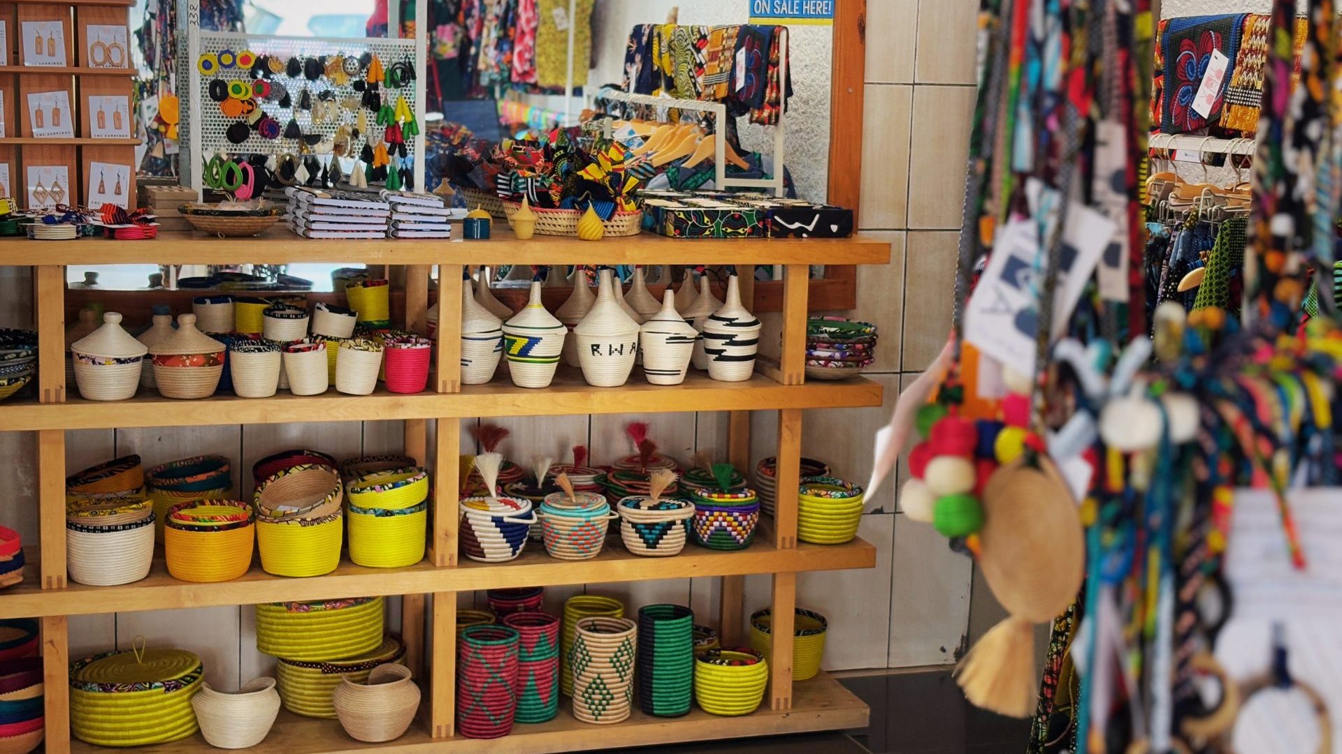 Interior of store, shelves lined with colorful handicrafts.