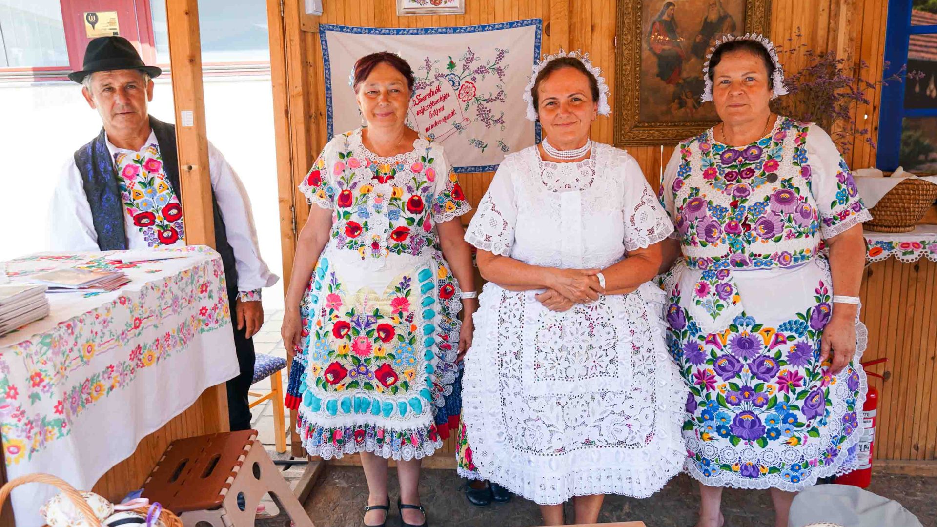 A row of people in traditional Hungarian clothing.