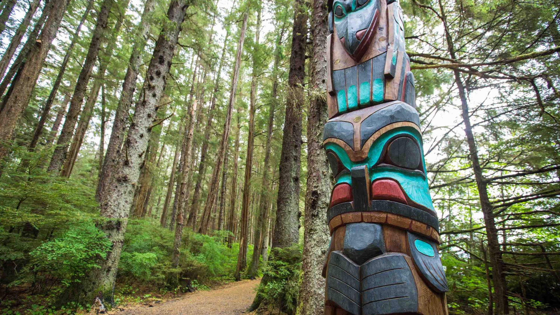 A totem pole in a forest.