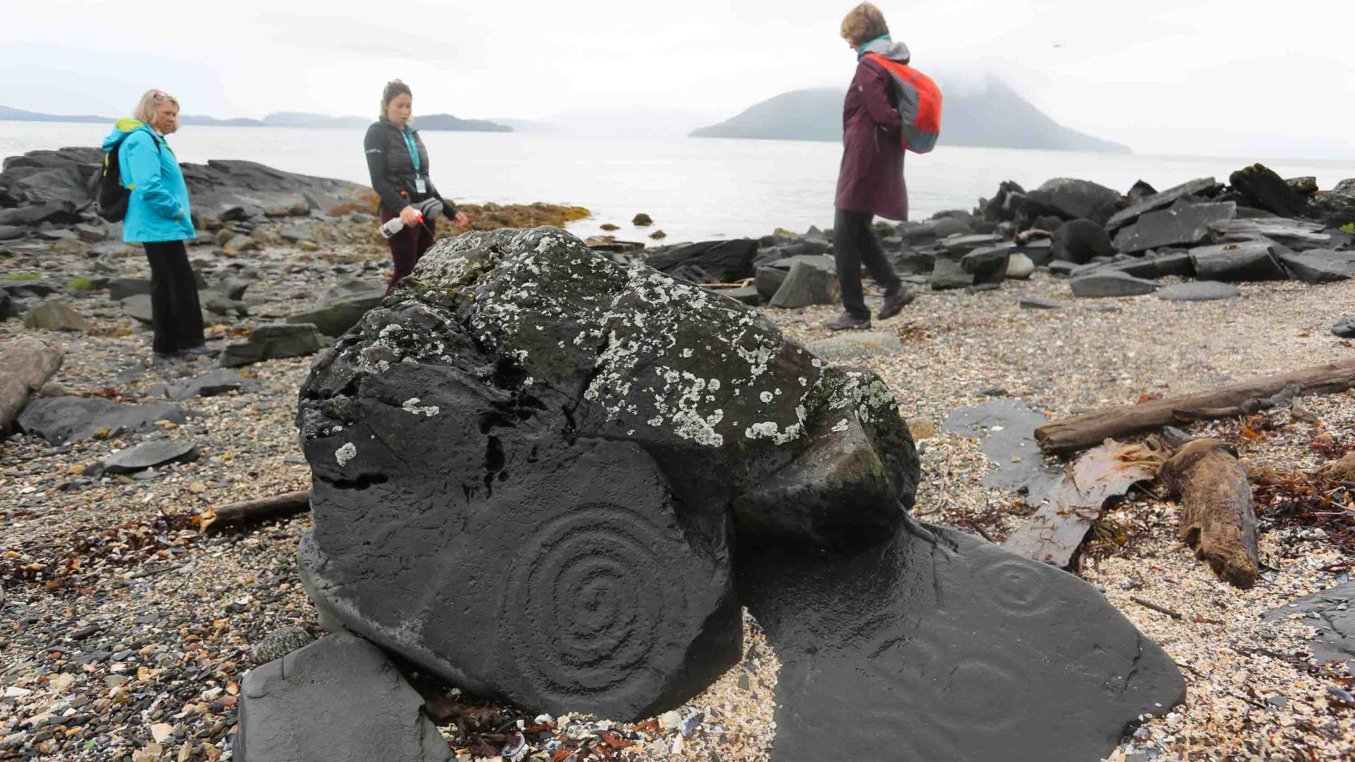A petroglyph on a pebbly beach.