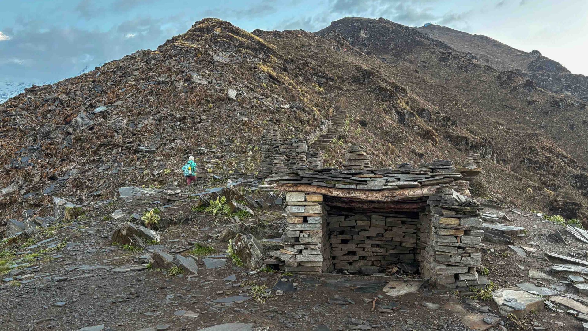 A stone animal shelter in mountains.