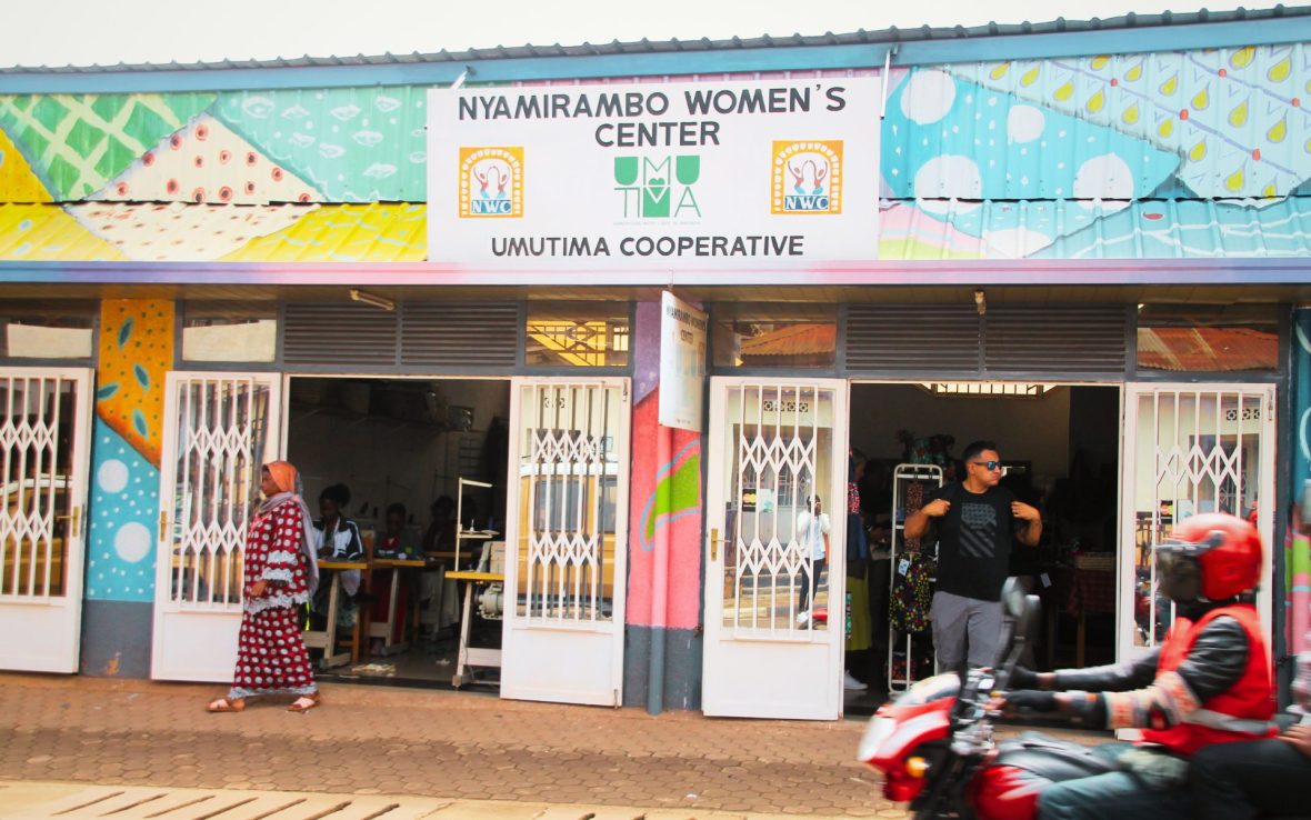 Colorful signage at front of store, signs read 'Nyamirambo Women's Center'.