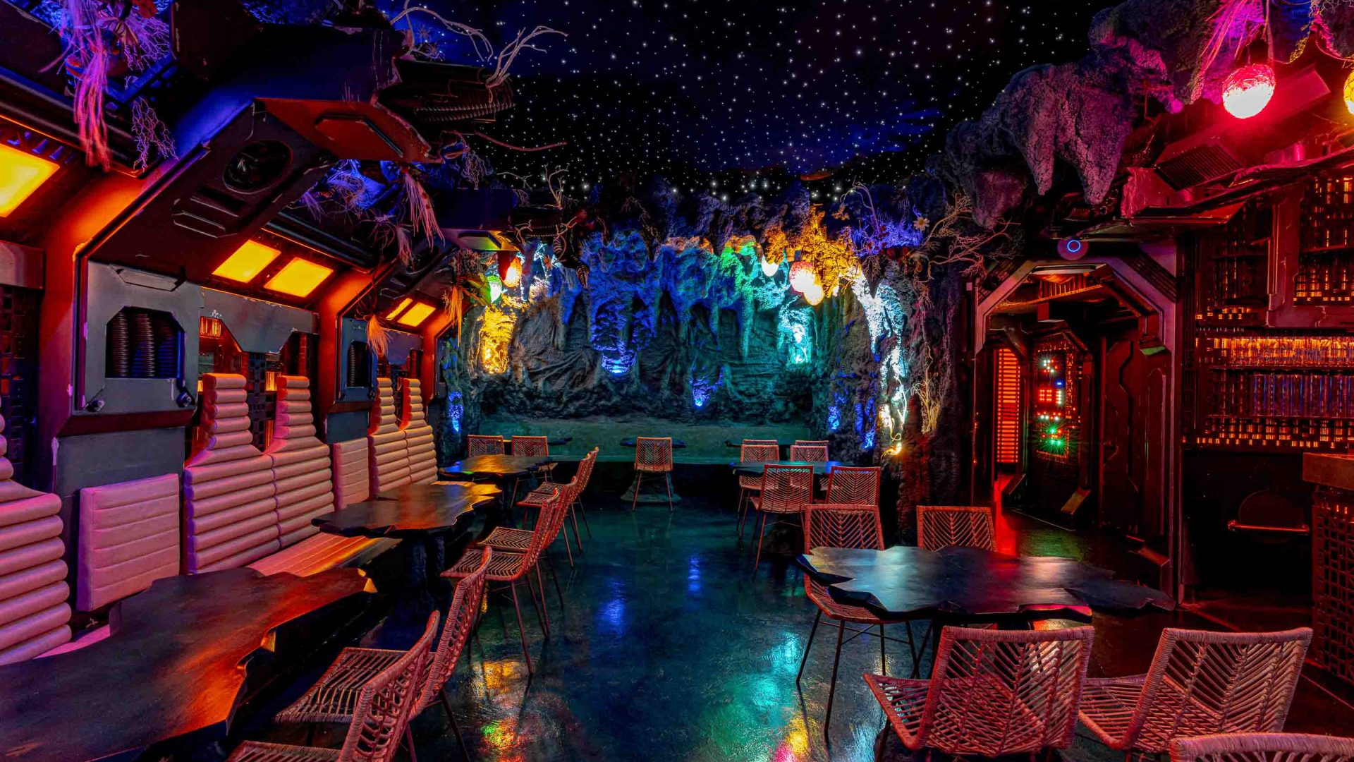 The interior of Mothership has dim, colorful lighting and intricate walls and ceilings.