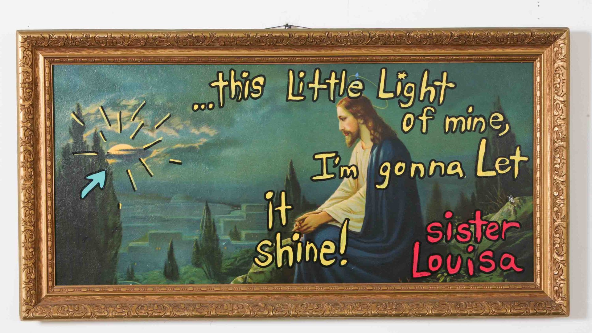 A picture of Jesus in a frame with words written over it.