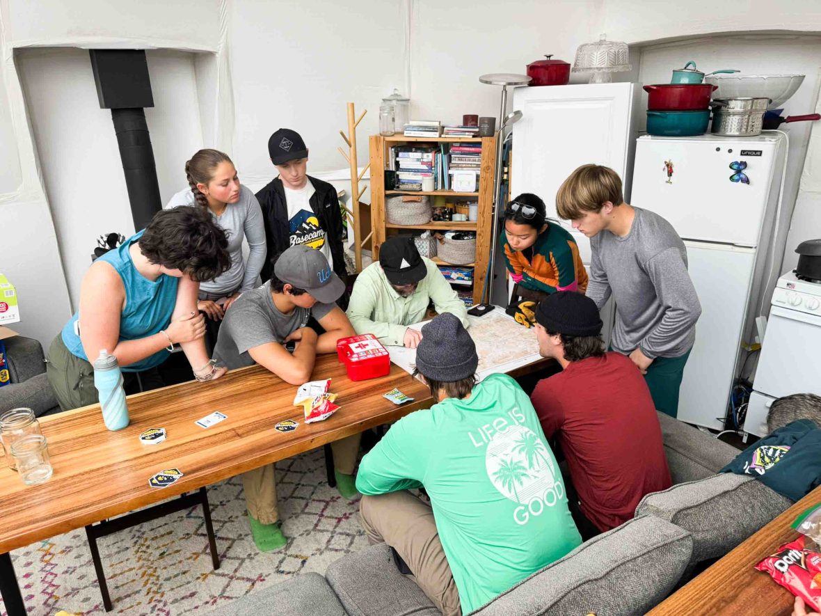 A group of teenagers look at a map.