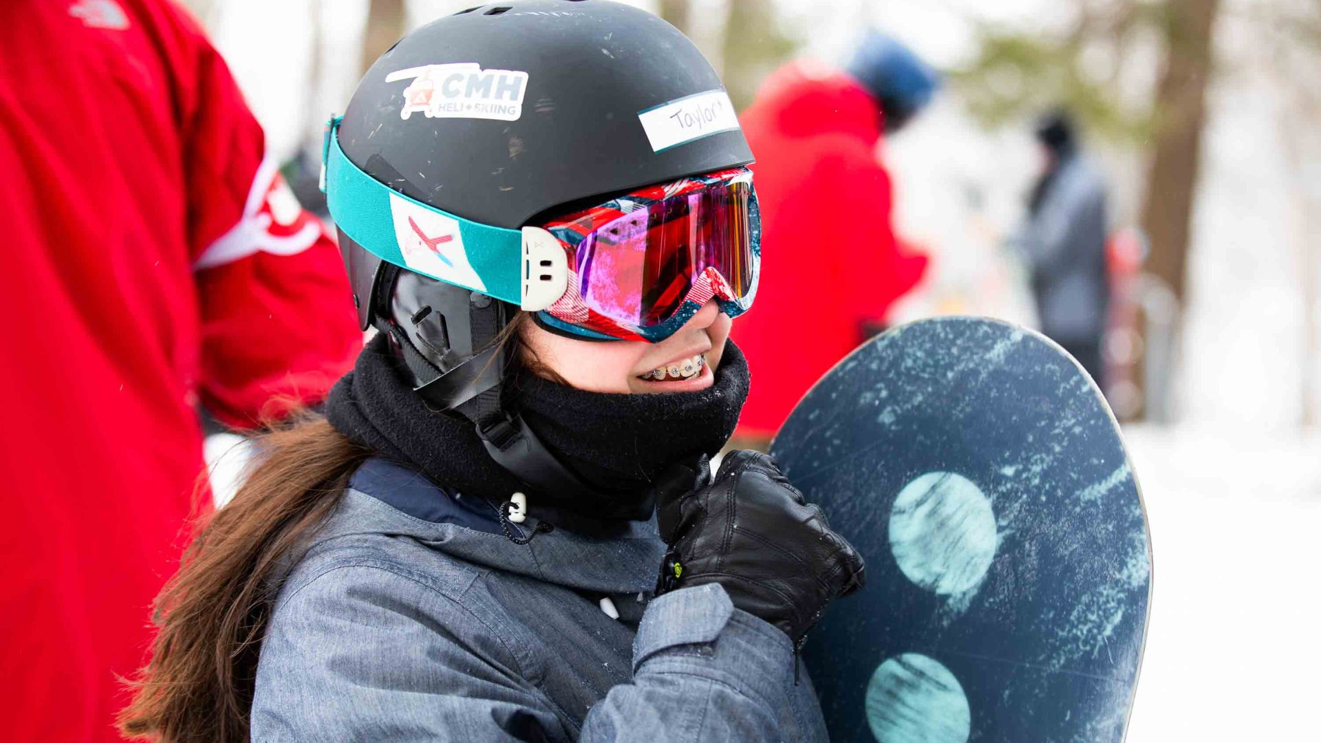 A young girl and her snowboard.