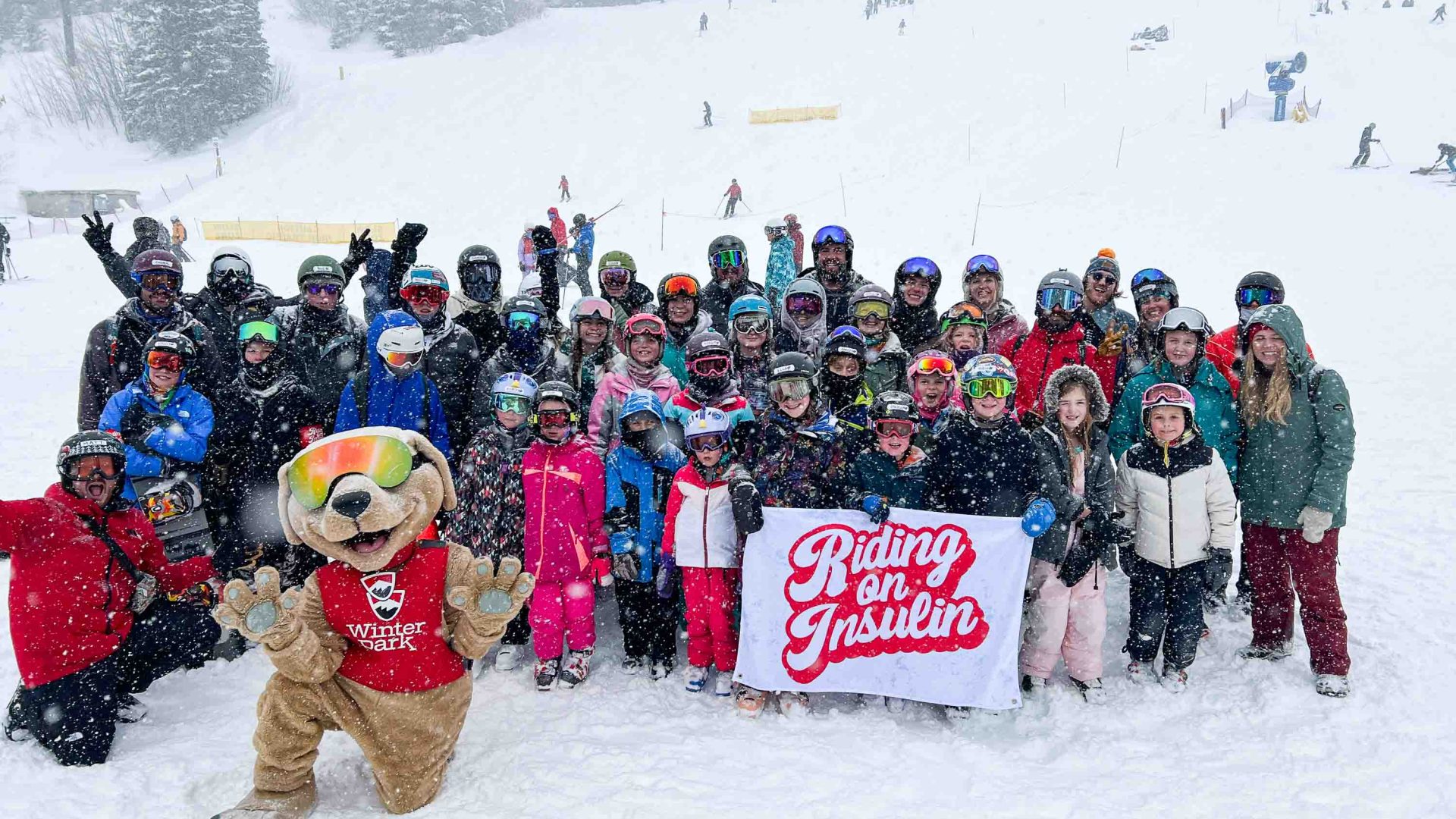 A group photo of kids in a snow camp.