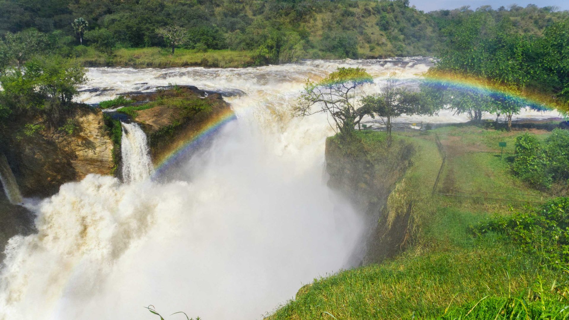 A waterfall with a rainbow in the water.