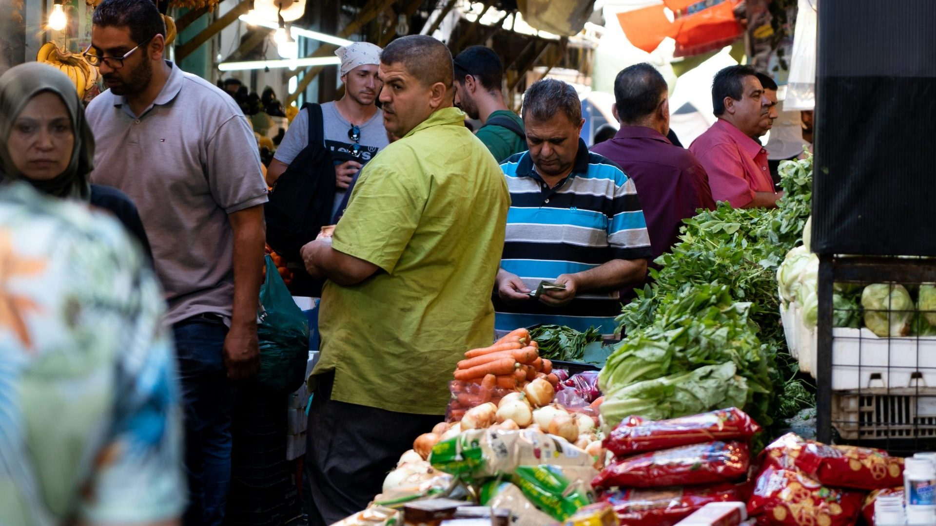People in a crowded marketplace, fruits and vegetables