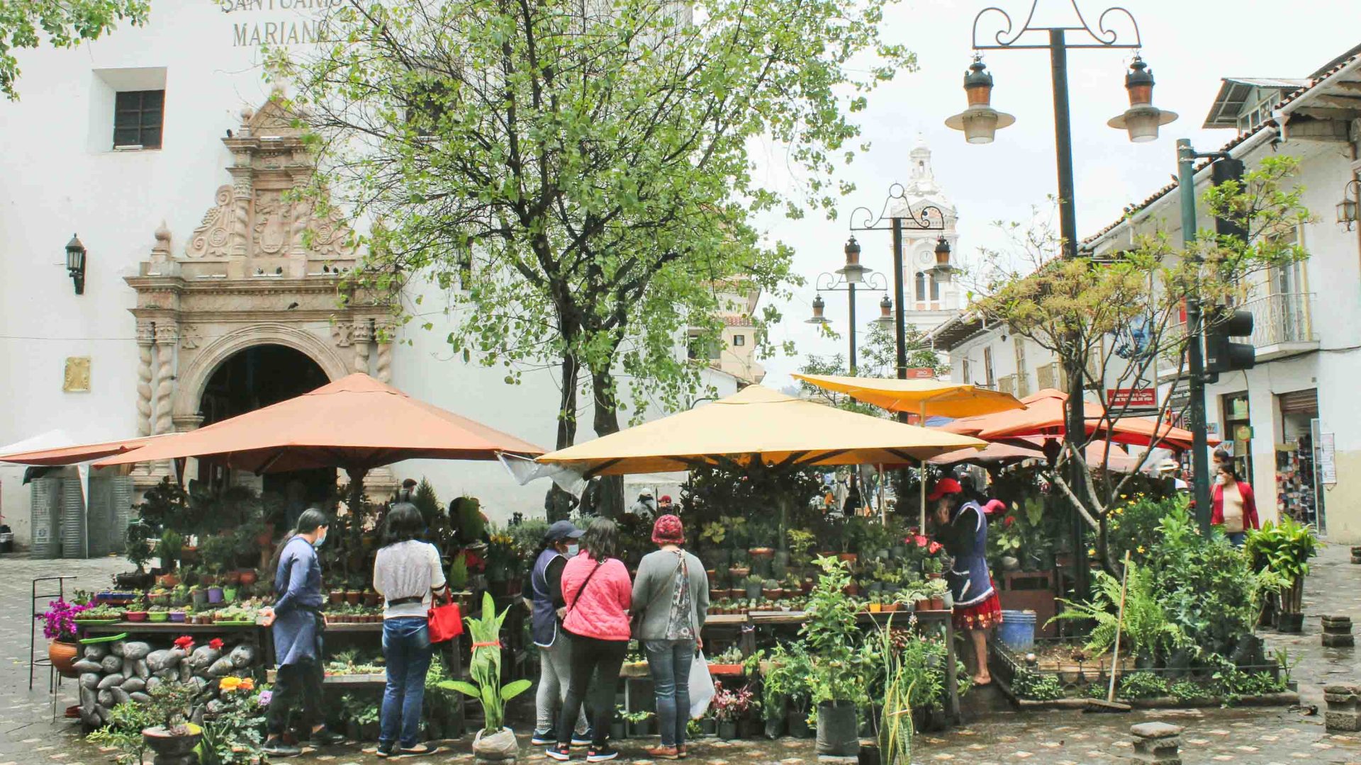 People at markets in a square in Cuenca.