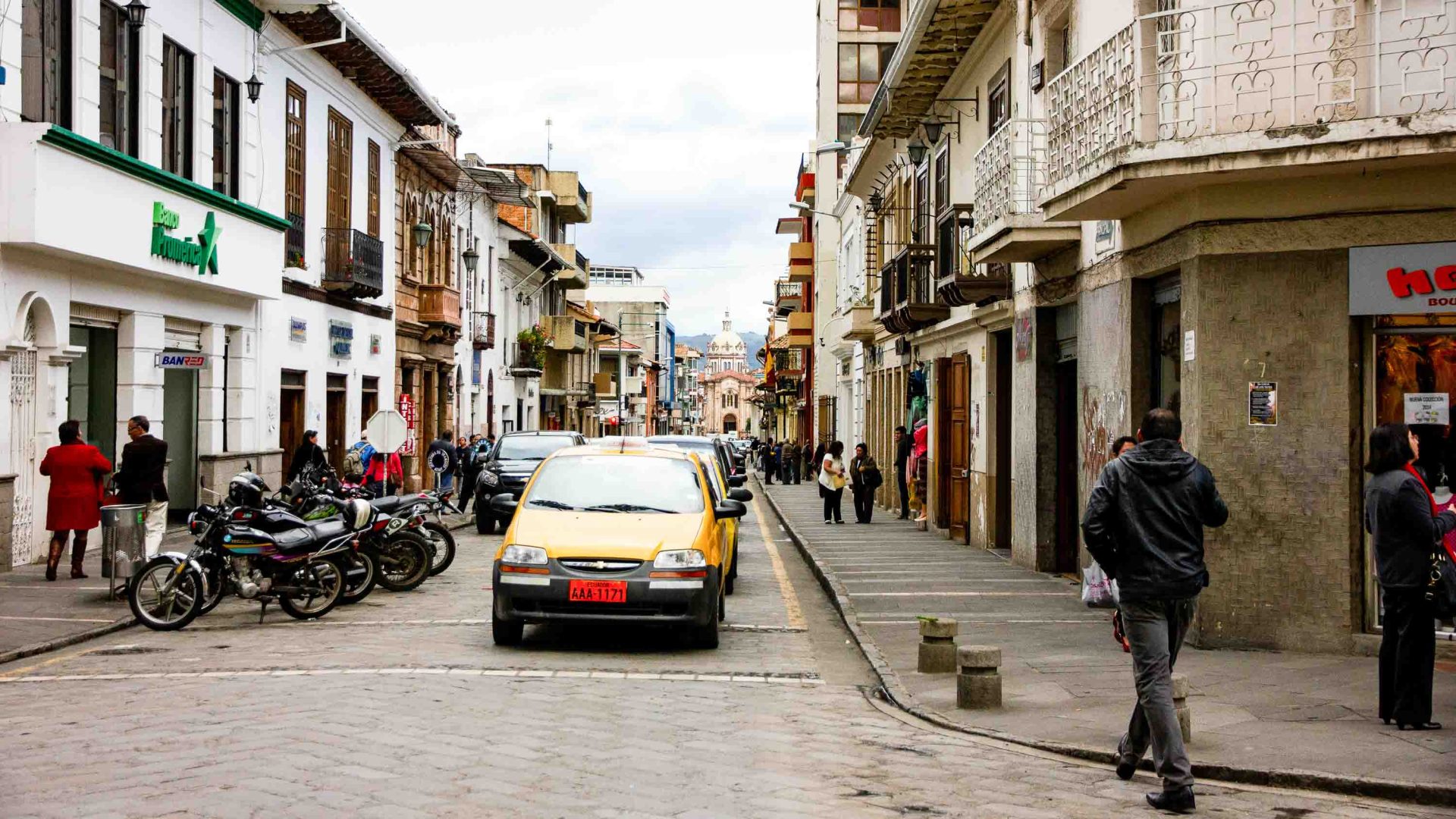 A car drives down a paved street.