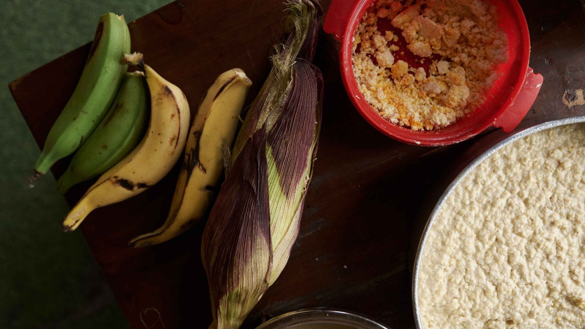 Corn and bananas alongside two bowls.