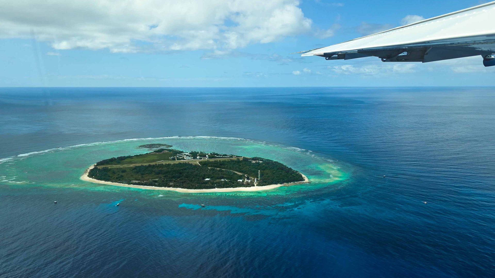 Lady Elliot Island as seen from the small plane that flies tourists to the island. A wing of the plane and the island is visible.